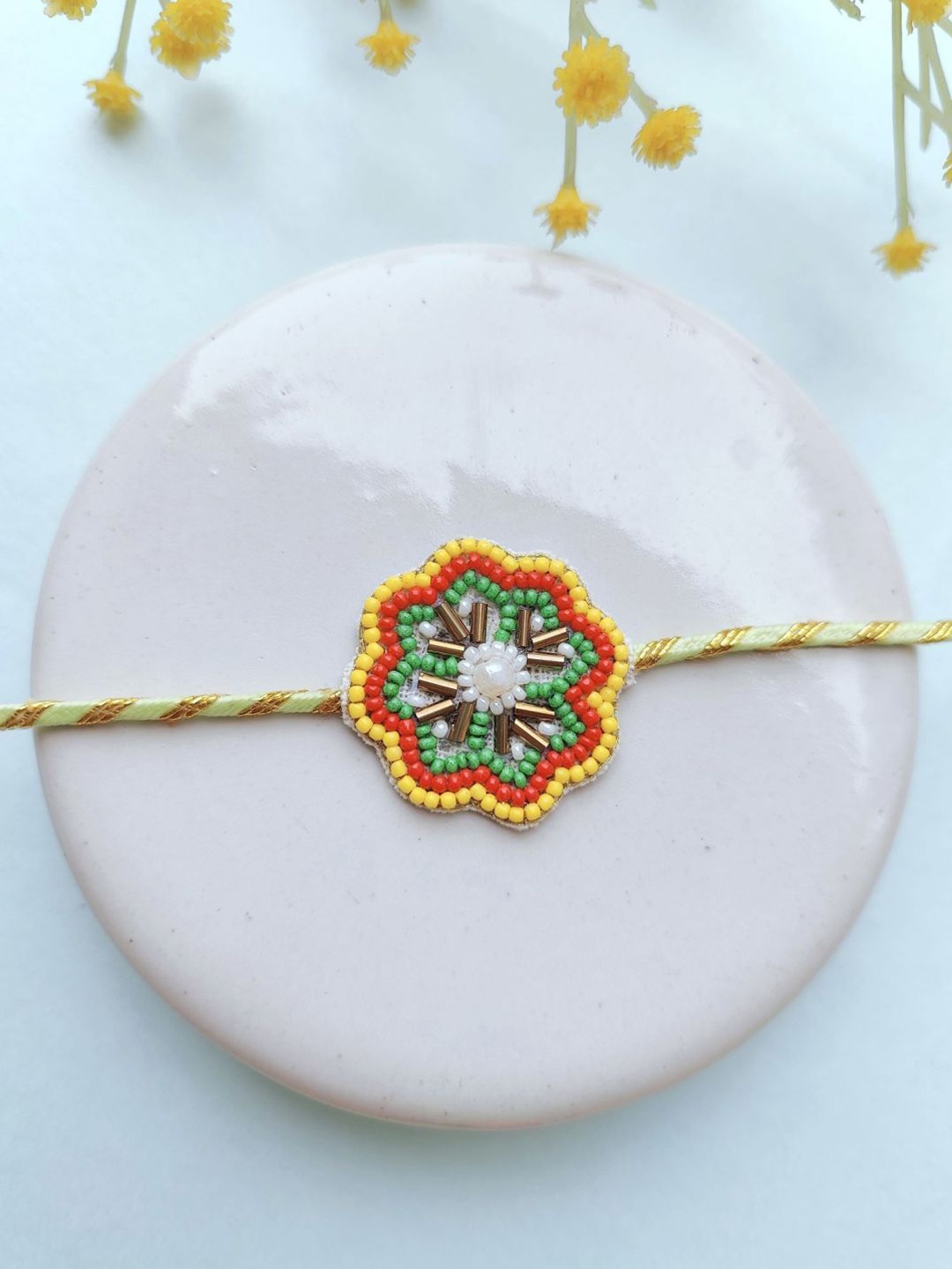 

Crunchy Fashion Flower Beaded Thread Rakhi, Yellow
