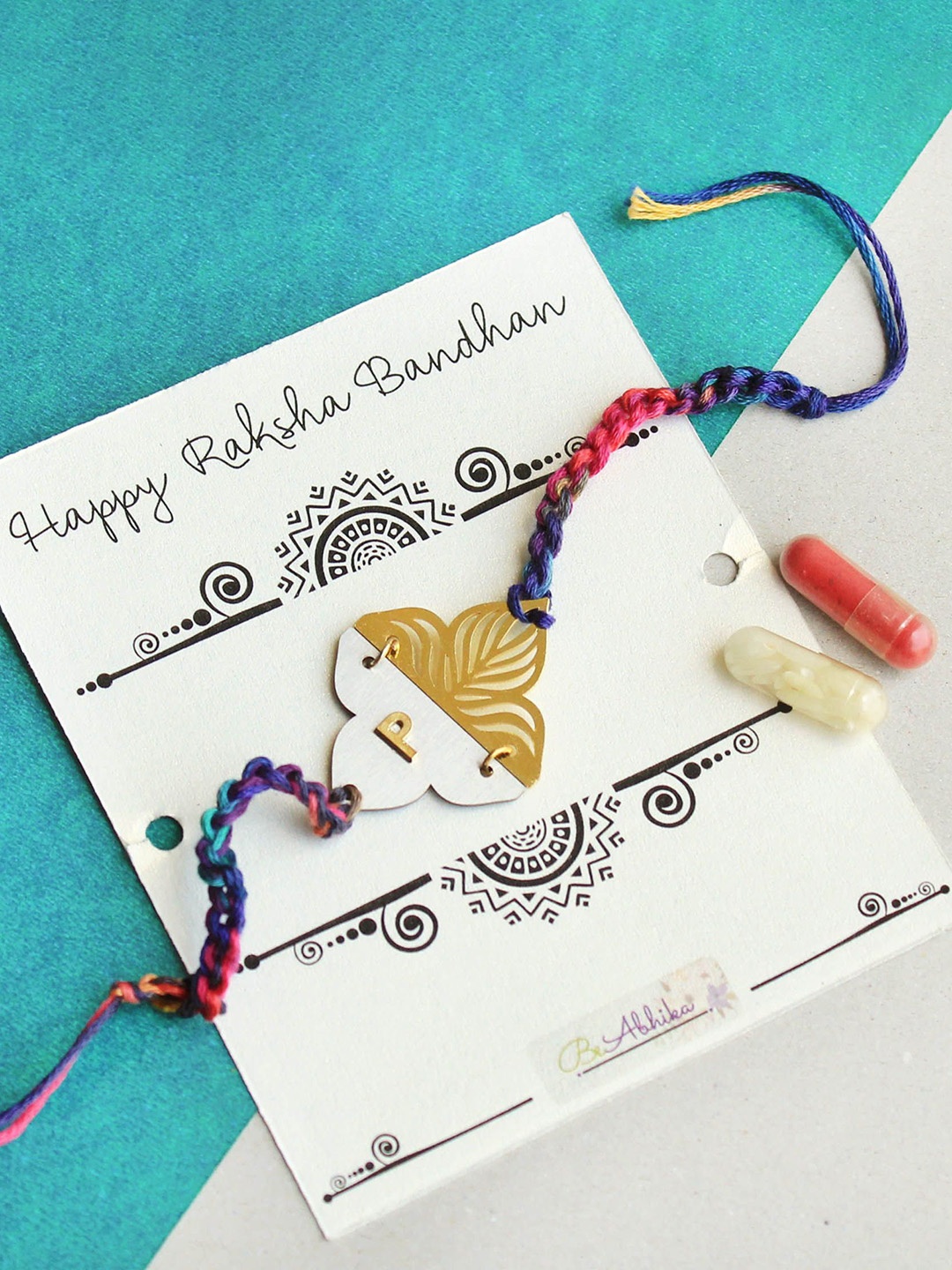 

BeAbhika " D " Initial Personalised Floral Plate Thread Rakhi with Roli Chawal Capsules, Red