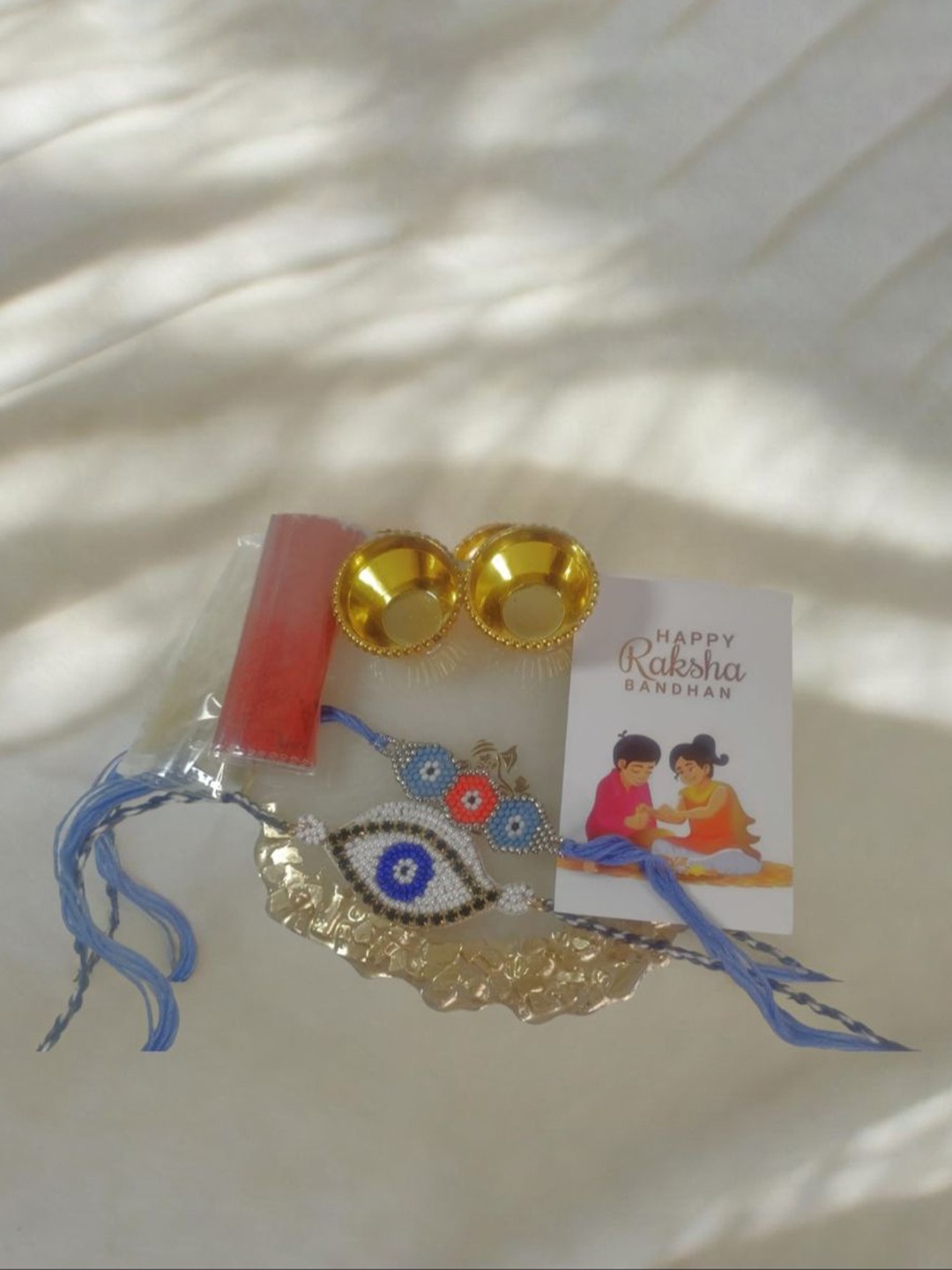 

PRIAANSHA CREATIONS Set Of 3 Beaded Thread Rakhis With Thali Roli Chawal & Greeting Card, Blue