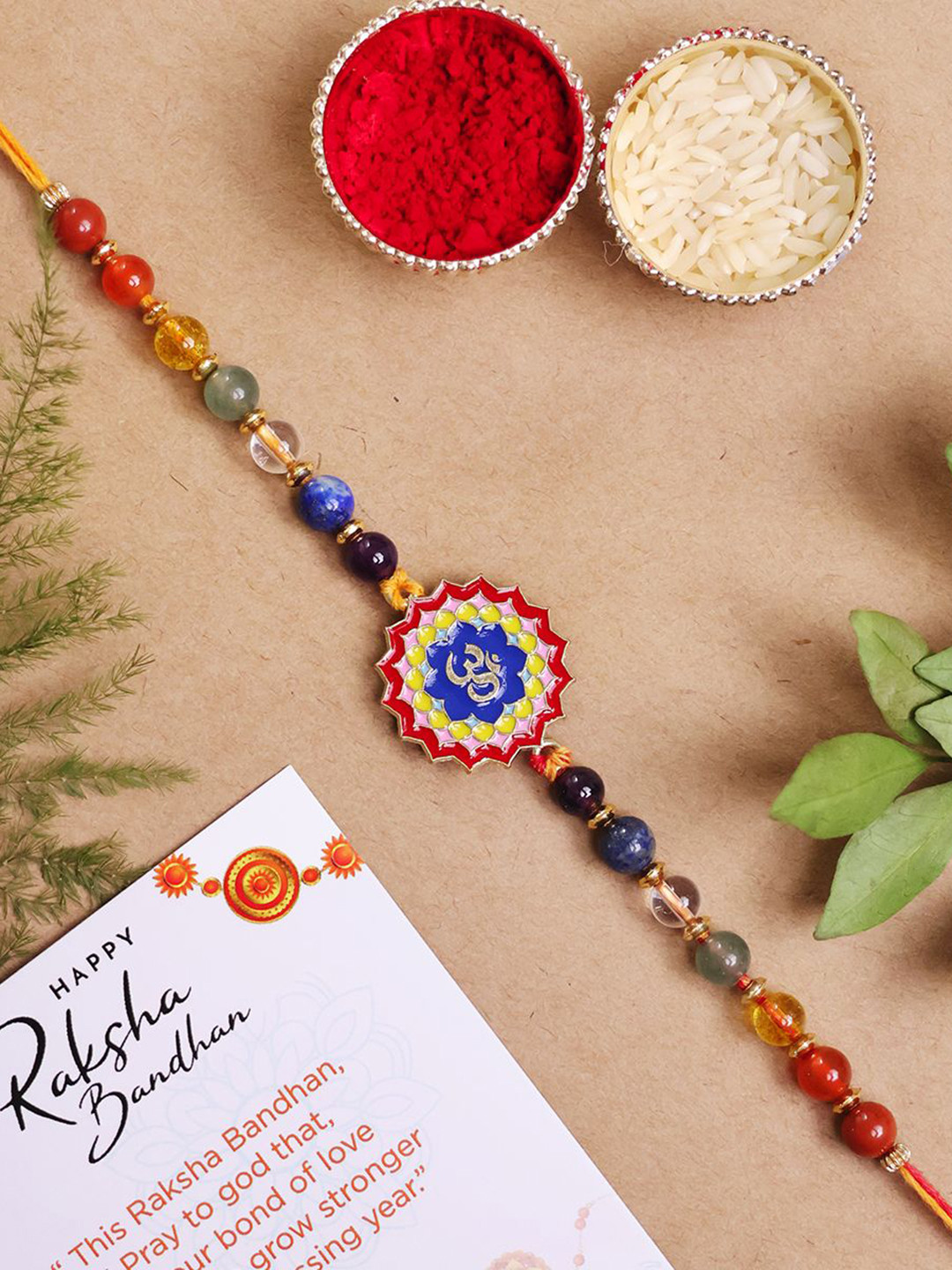 

Shubhanjali Set Of 2 Beaded 7 Chakra Om Thread Rakhis With Roli Chawal & Greeting Card, Grey