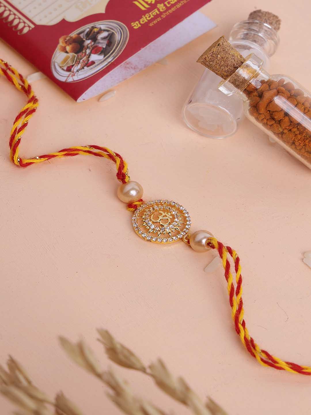 

PANASH- 925 Sterling Gold -Plated Om Shaped CZ Stone Studded Rakhi With Roli Chawal
