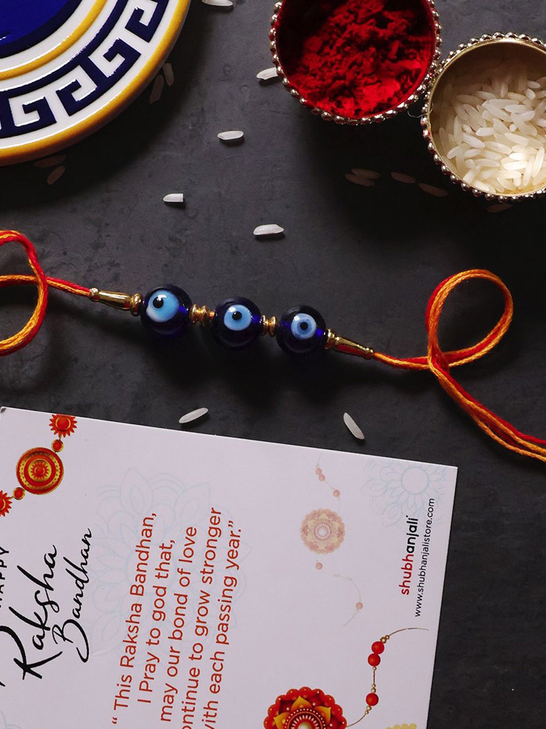 

Shubhanjali Evil Eye Beads Thread Rakhis With Roli Chawal & Greeting Card, Blue