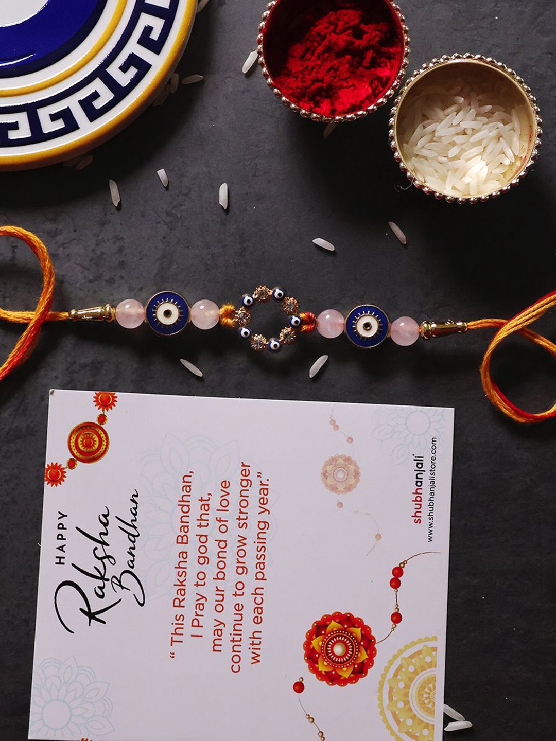 

Shubhanjali Set Of 2 Evil Eye Thread Rakhis With Roli Chawal & Greeting Card, Blue