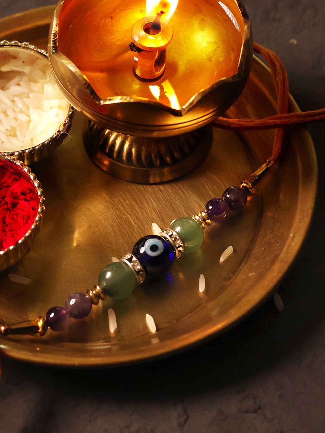 

Shubhanjali Set Of 2 Evil Eye Health & Luck Thread Rakhis With Roli Chawal & Greeting Card, Green