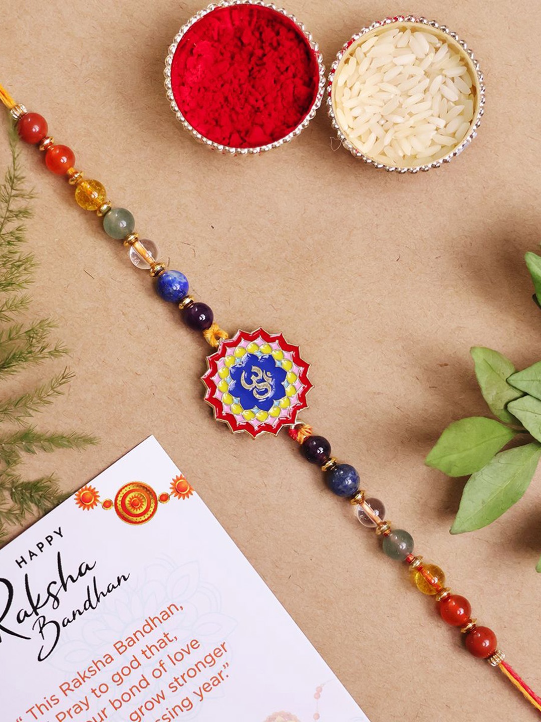 

Shubhanjali 7 Chakra Om Beaded Thread Rakhis With Roli Chawal & Greeting Card, Red