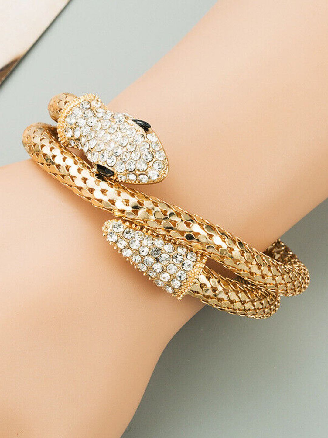 

VAGHBHATT Gold-Plated Stone-Studded Snake Shaped Cuff Bracelet