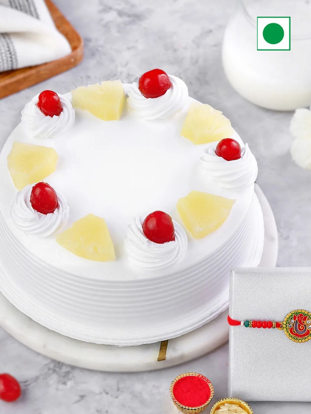 

fnp rakhi with eggless Pineapple Flavour Cake, Red