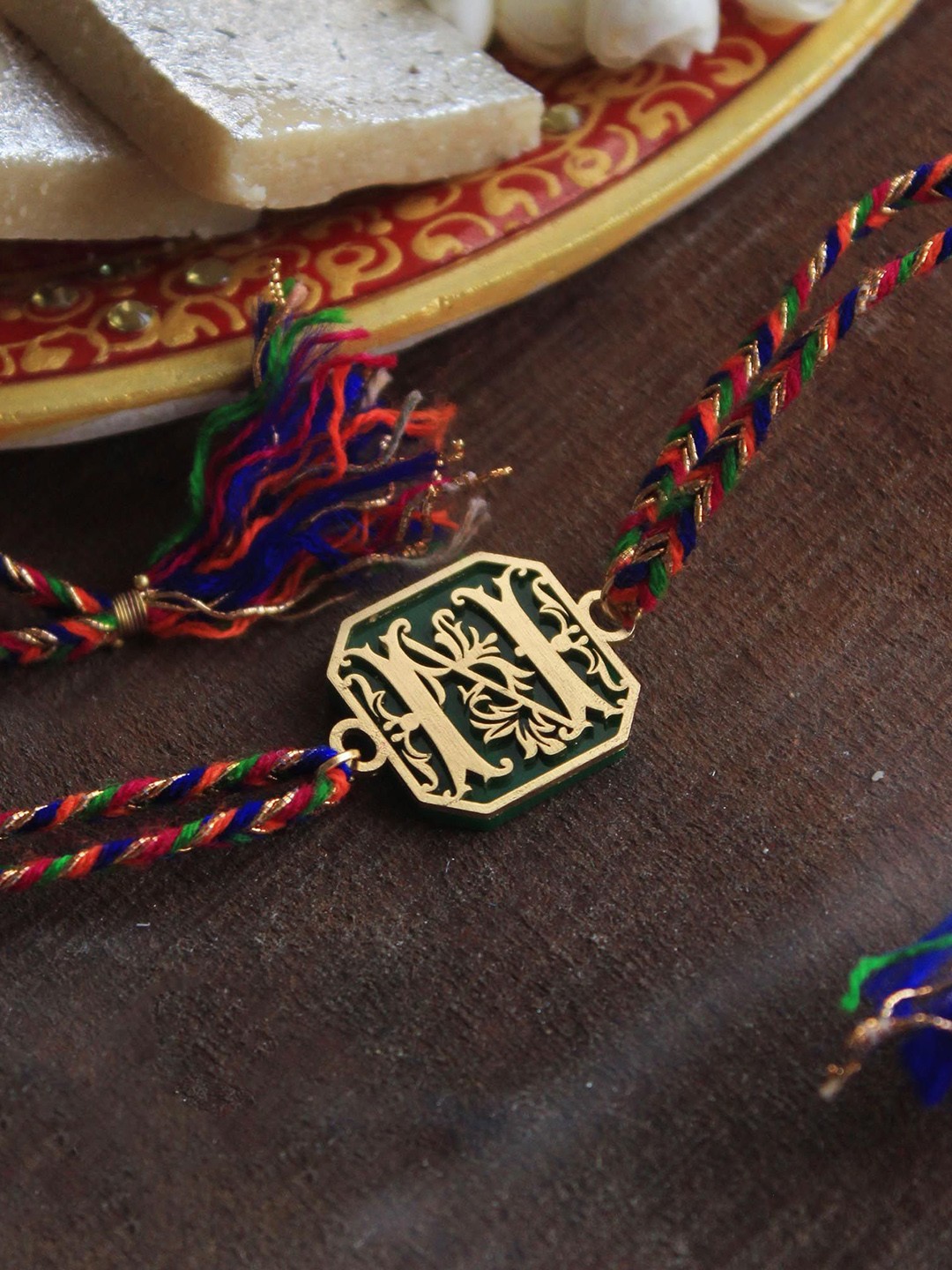 

BeAbhika H Initial Acrylic Thread Rakhi with Roli Chawal Capsules, Gold