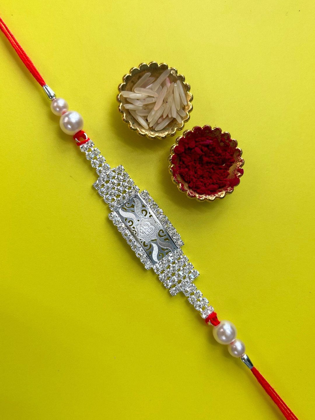 

LAIDA OM American Diamond Studded & Beaded Thread Rakhis With Roli Chawal, Silver