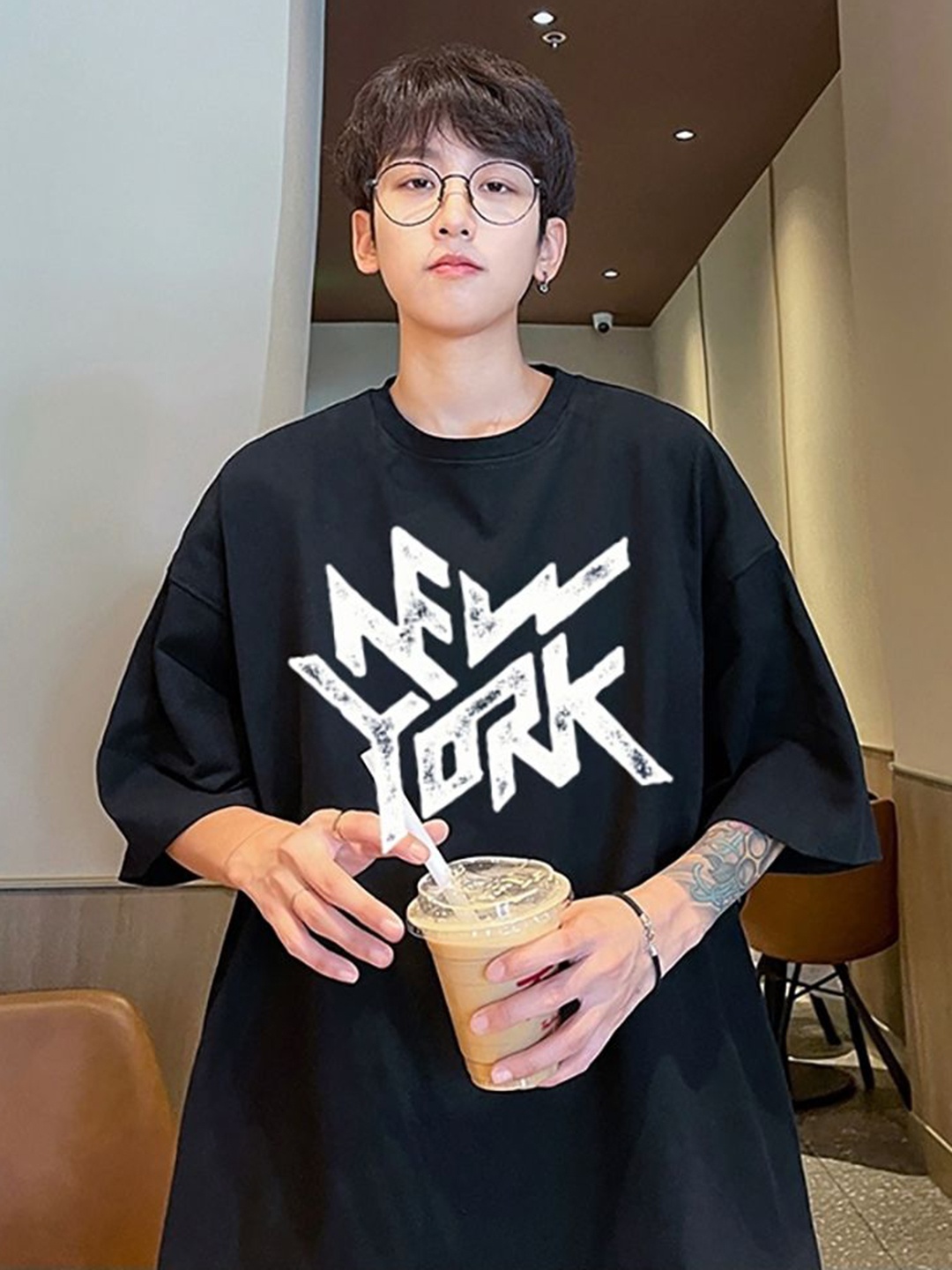 

StyleCast x Revolte Men Typography Printed Round Neck Oversized T-shirt, Black