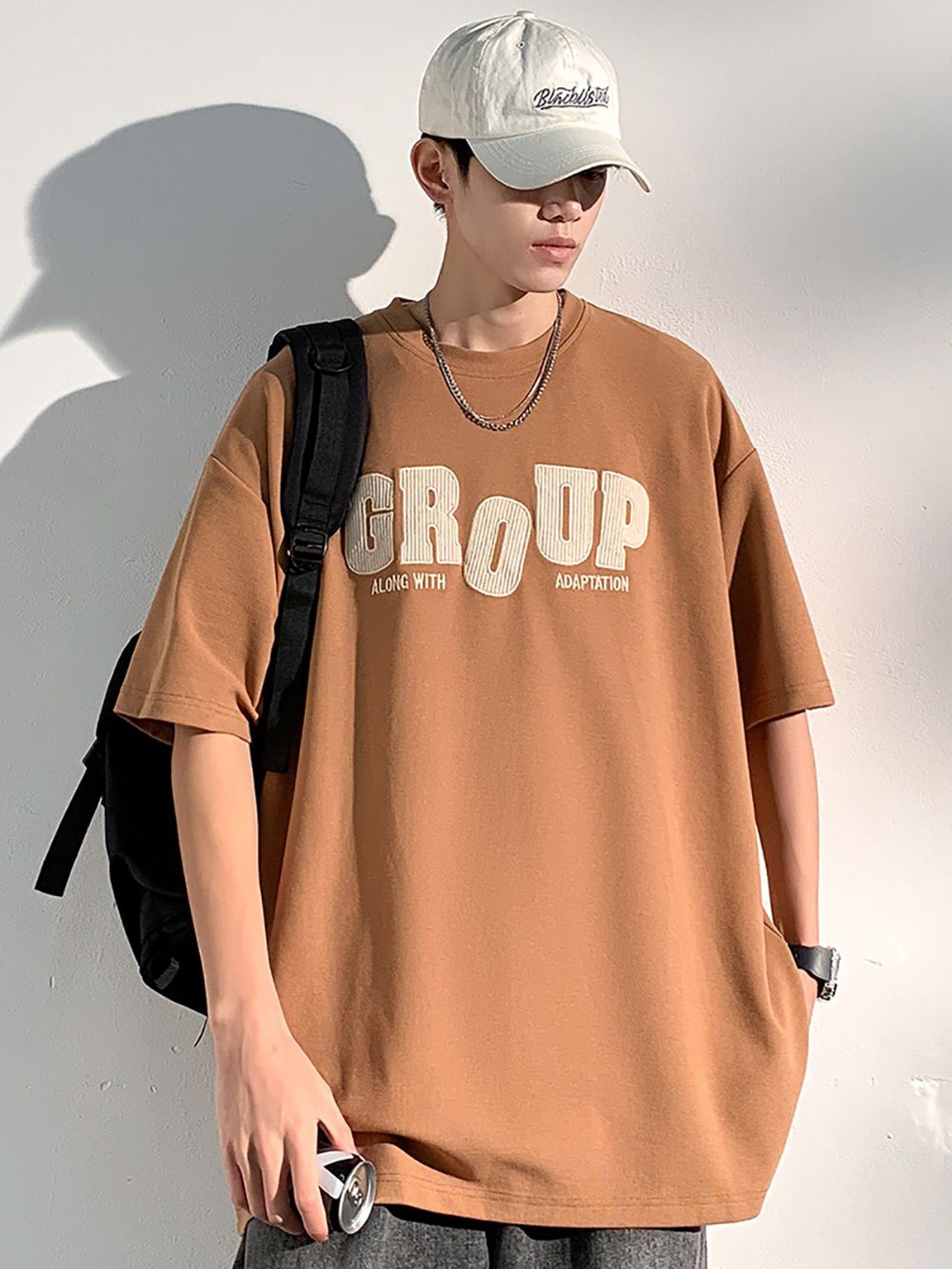 

StyleCast x Revolte Men Typography Printed Round Neck Oversized T-shirt, Brown