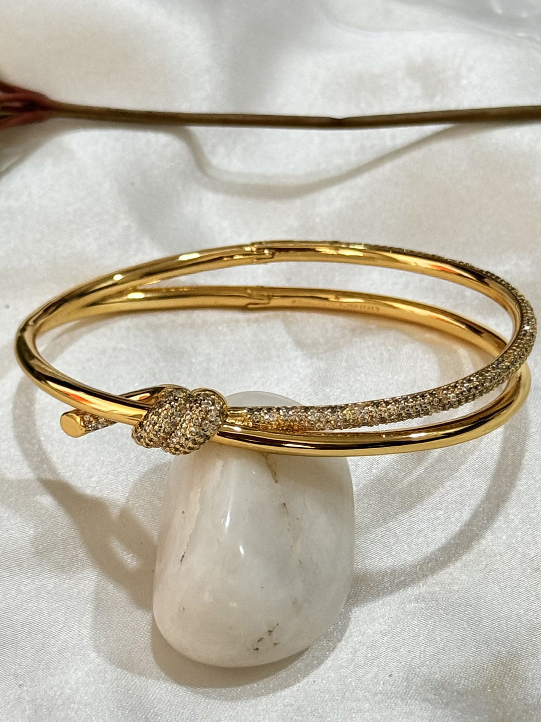 

The Jewellery Tale Brass American Diamond Gold-Plated Bangle-Style Bracelet