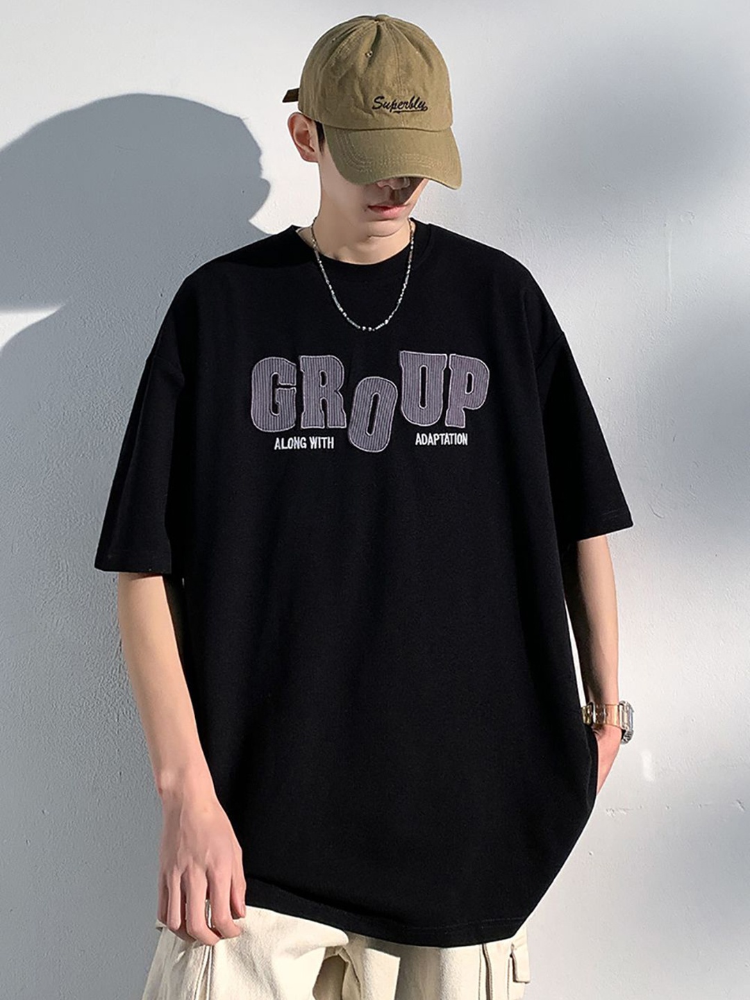 

StyleCast x Revolte Men Typography Printed Round Neck Oversized T-shirt, Black