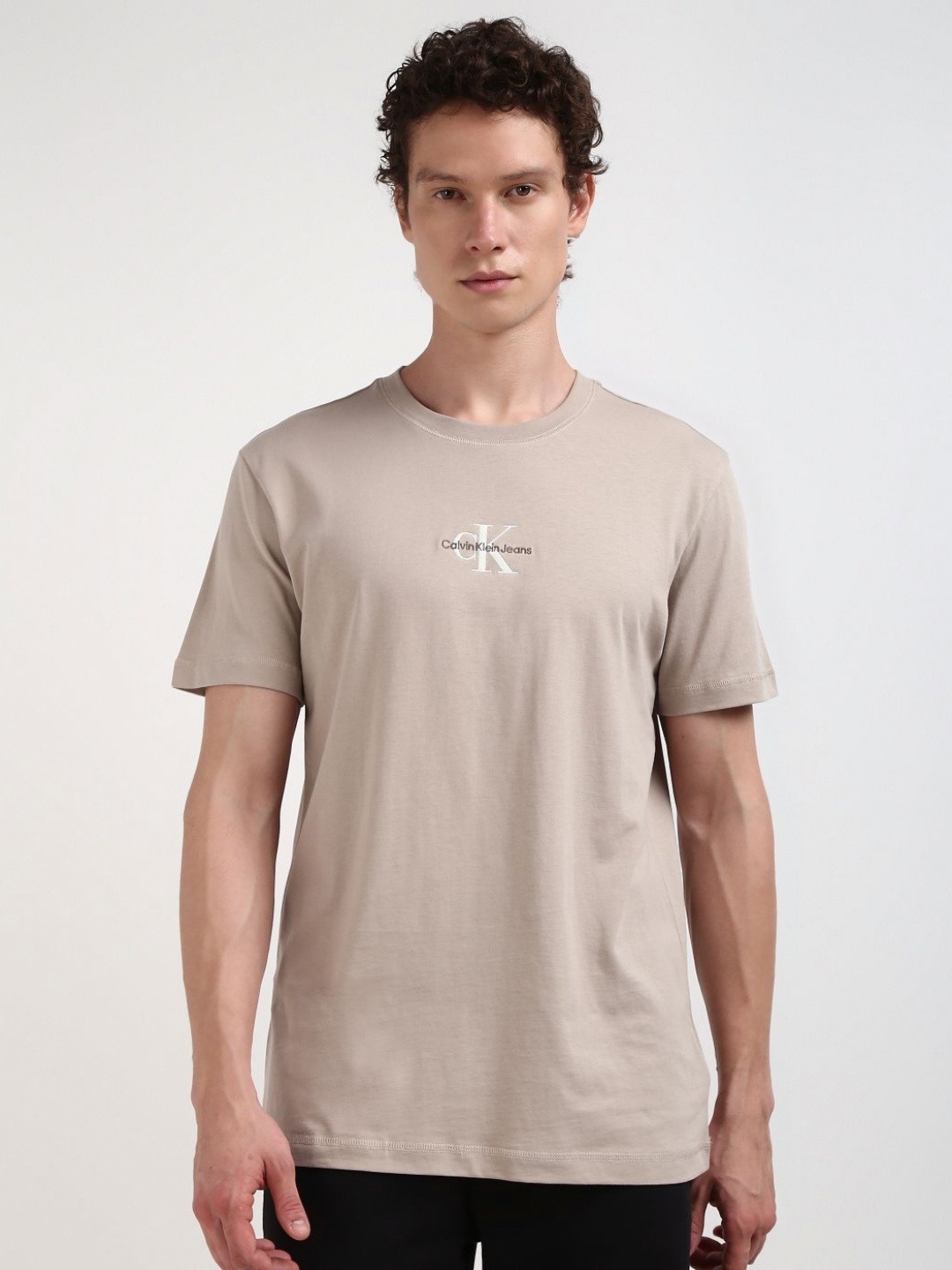 

Calvin Klein Jeans Men Solid Round Neck Cotton Tshirt, Beige