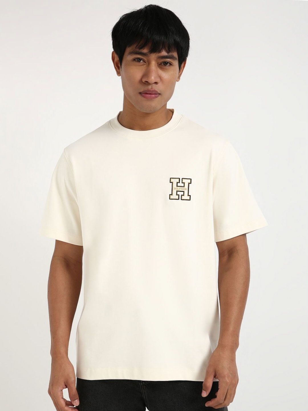

Tommy Hilfiger Men Solid Round Neck Cotton T-shirt, Off white