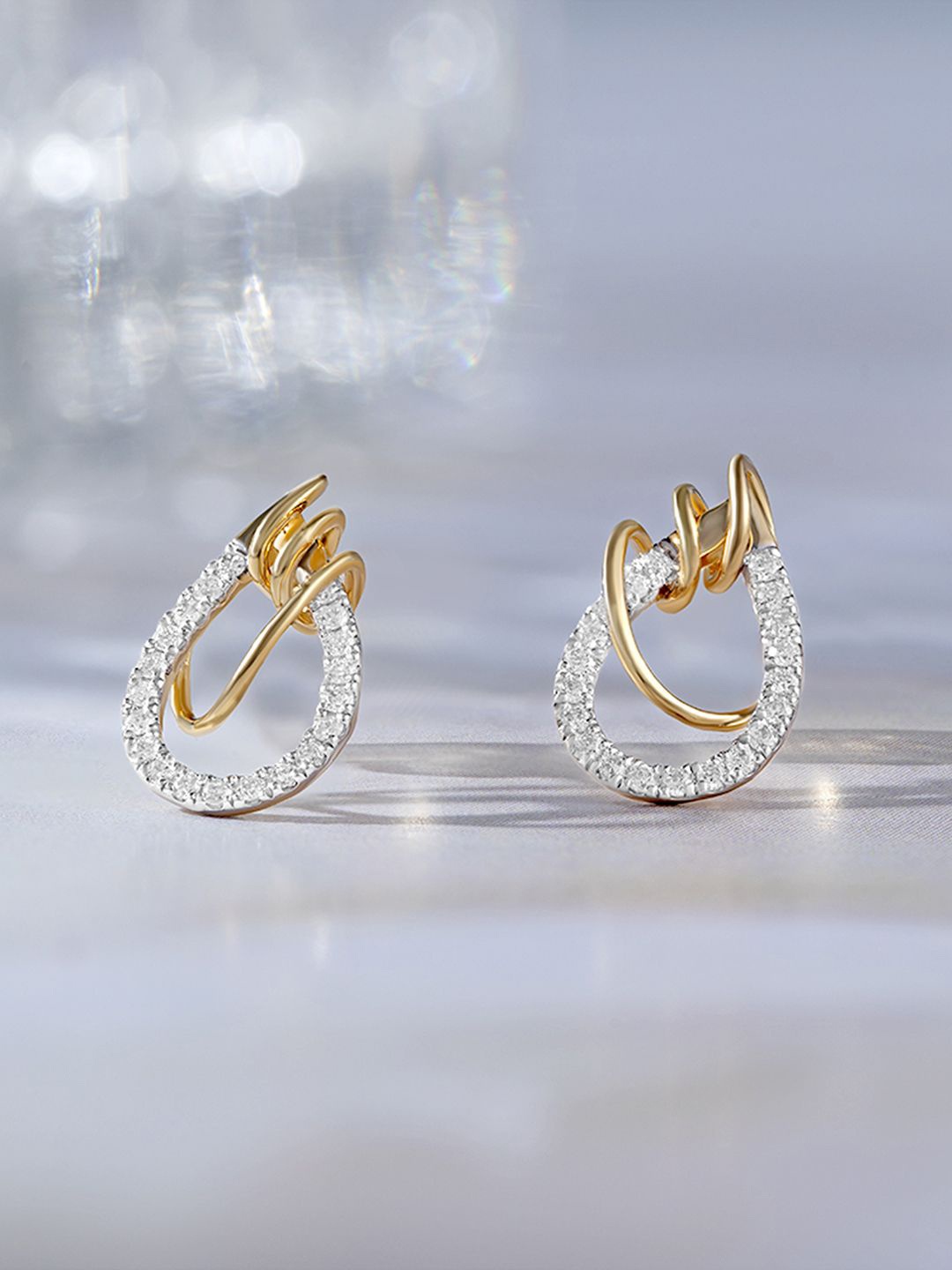

Mia by Tanishq Women Artistic Flow Gold & Diamond Stud Earrings 1.79 gm