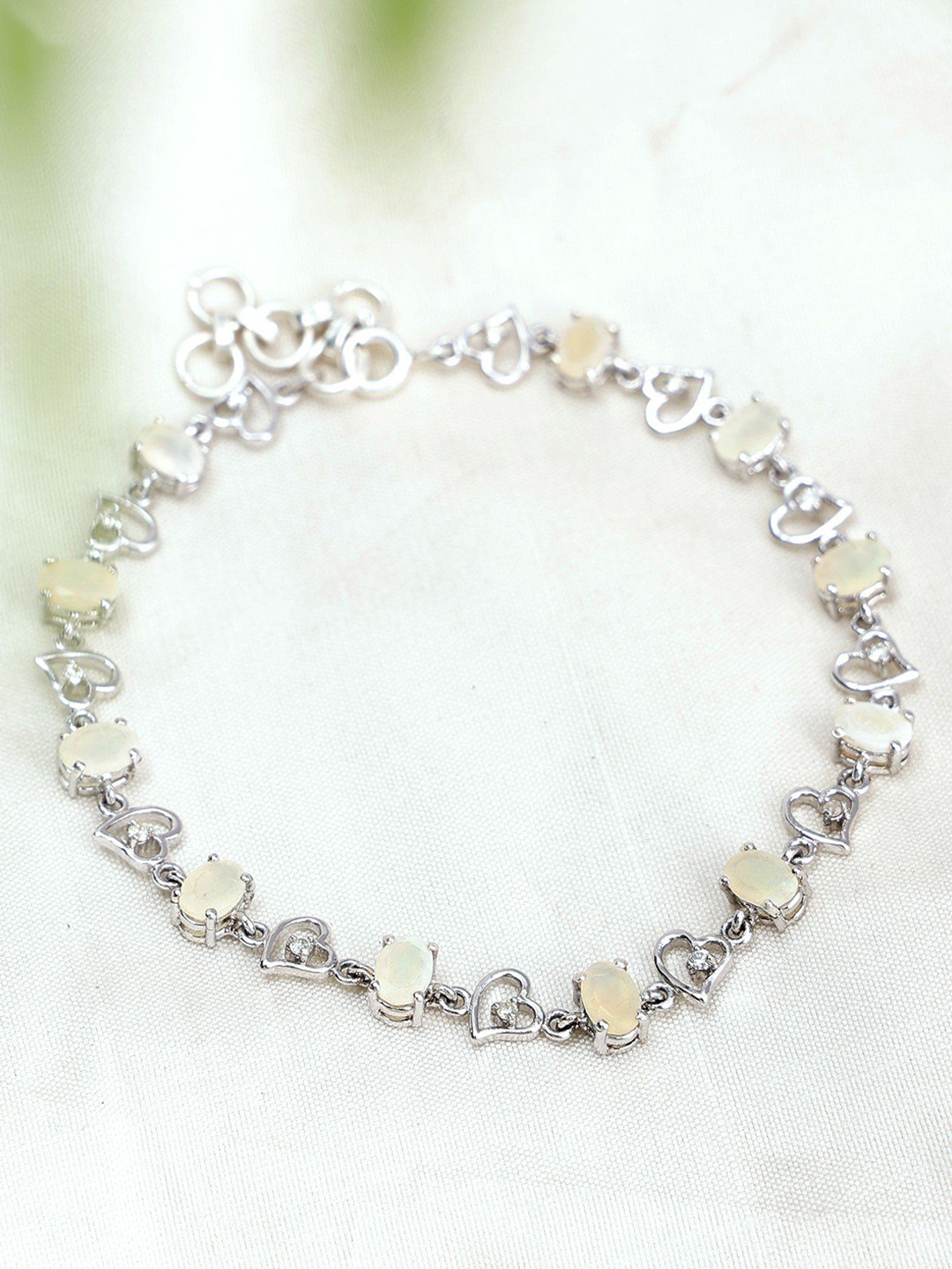 

Exotic India Oval Cut Heart Shape Sterling Silver Bracelet With Ethiopian Opal