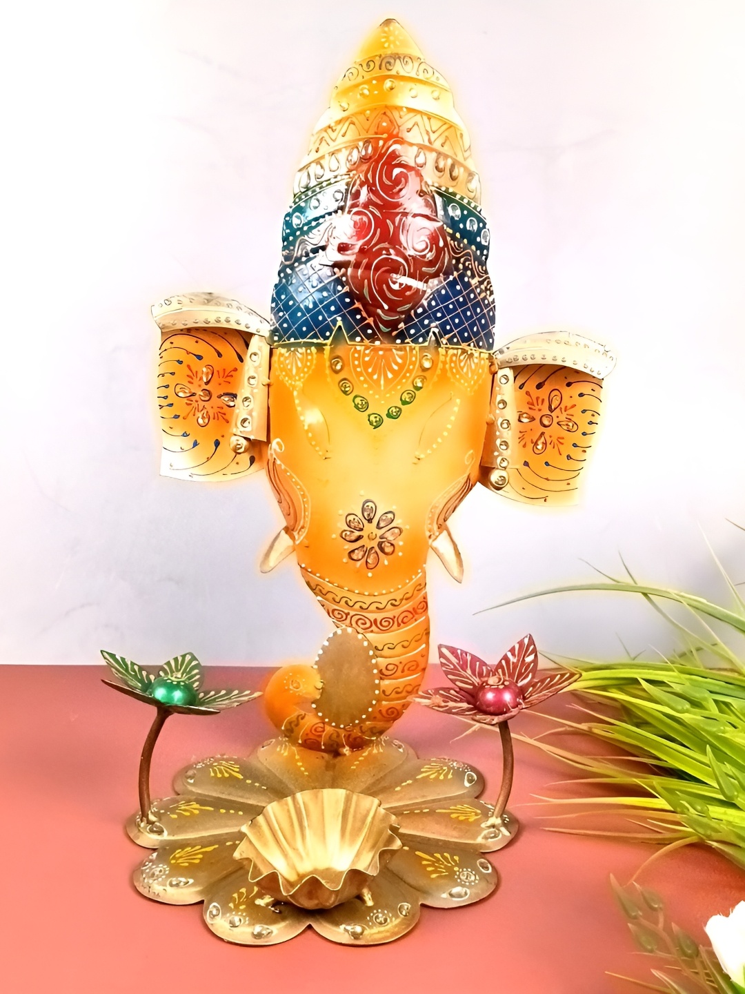 

apka mart Orange Colored & Green Lord Ganesha Metal Showpiece With Tea Light Candle Holder