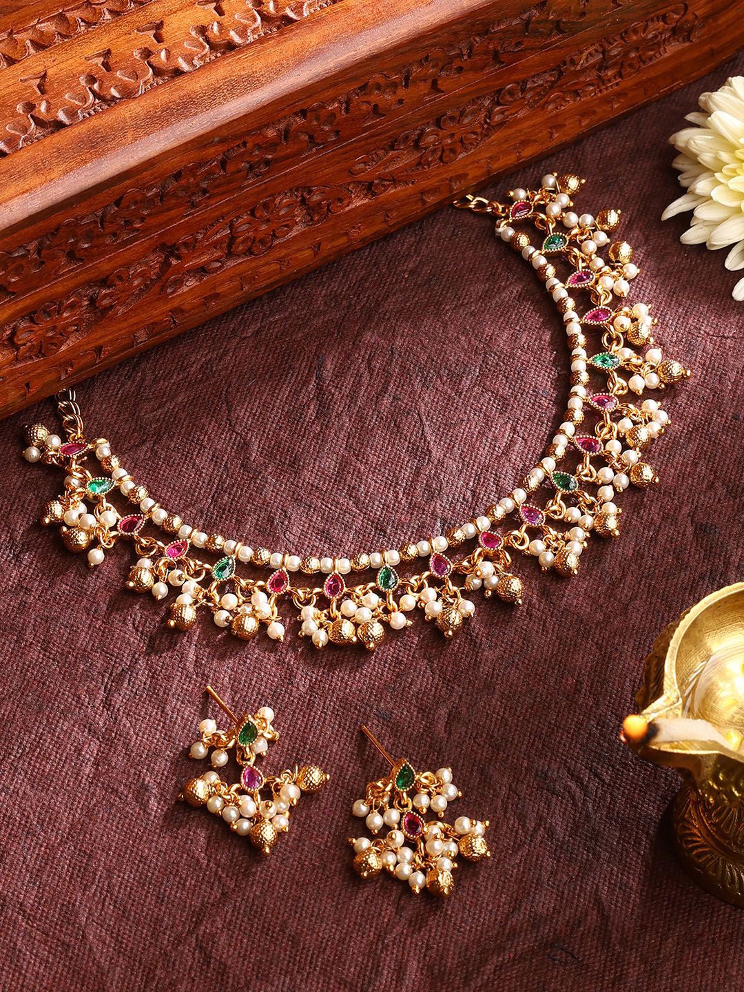 

Priyaasi Gold-Plated Floral Simple Pearls & Ruby Stone-Studded Beaded Jewellery Set