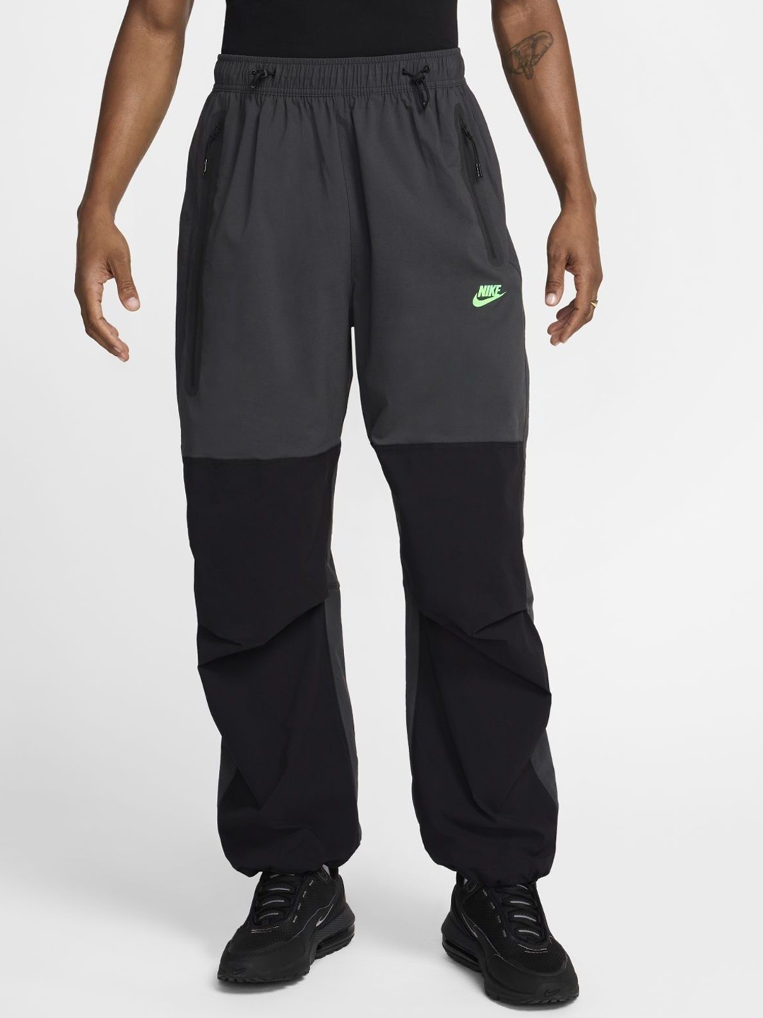 

Nike Men Solid Tech Men's Woven Open-Hem Loose Fit Trousers, Black