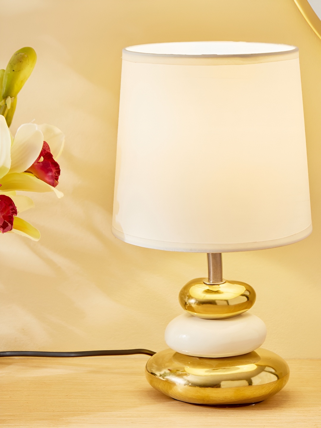 

Home Centre Glint Pebble Gold-Toned Ceramic Frustum Shaped Table Lamp