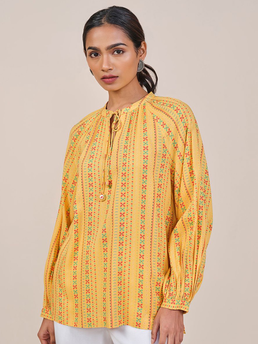 

Global Desi Women Mustard Viscose Rayon Print Tie-Up Neck long Sleeves Top