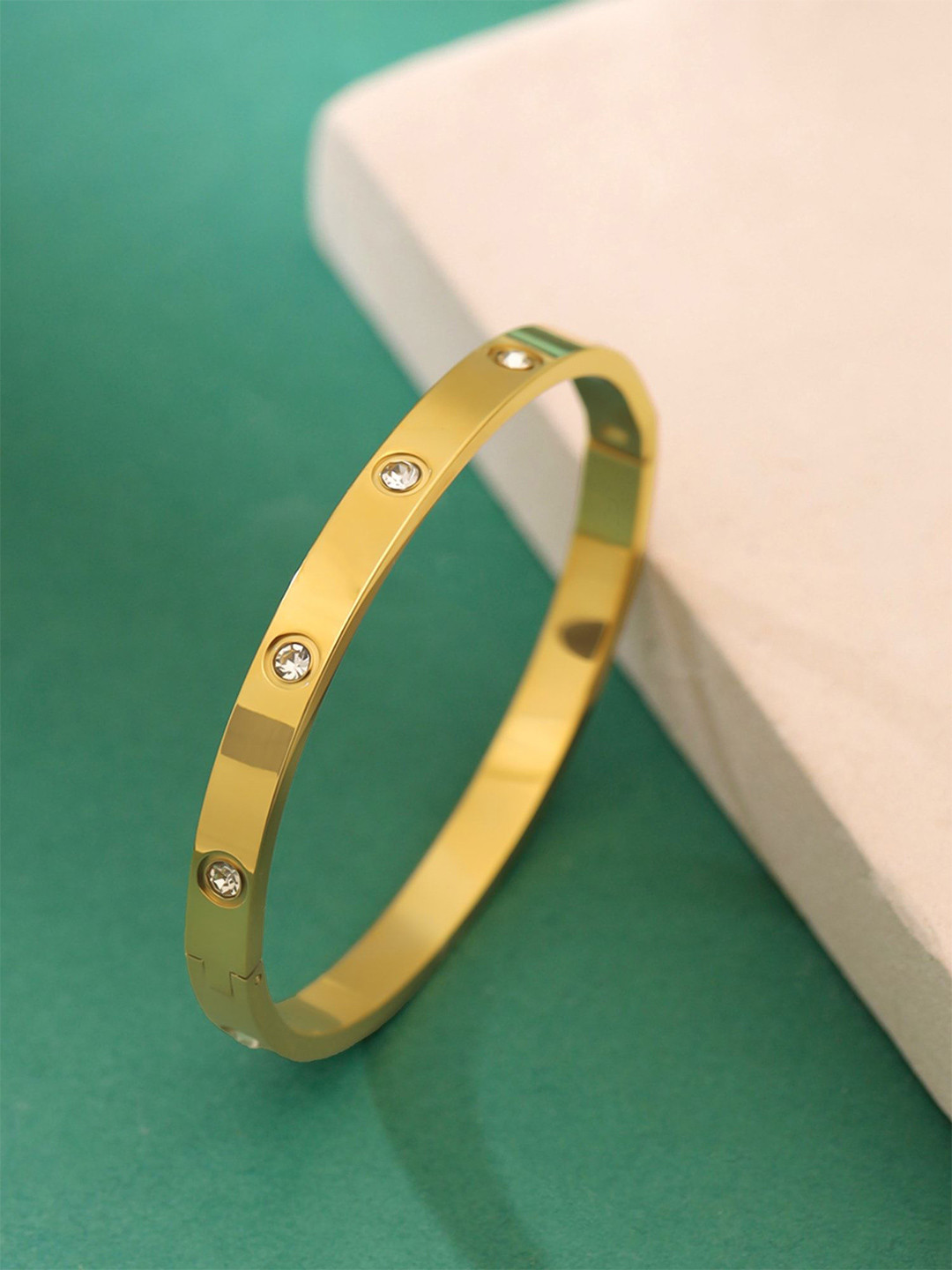 

Yellow Chimes Stainless Steel Gold-Plated Crystals Stone-Studded Bangle-Style Bracelet