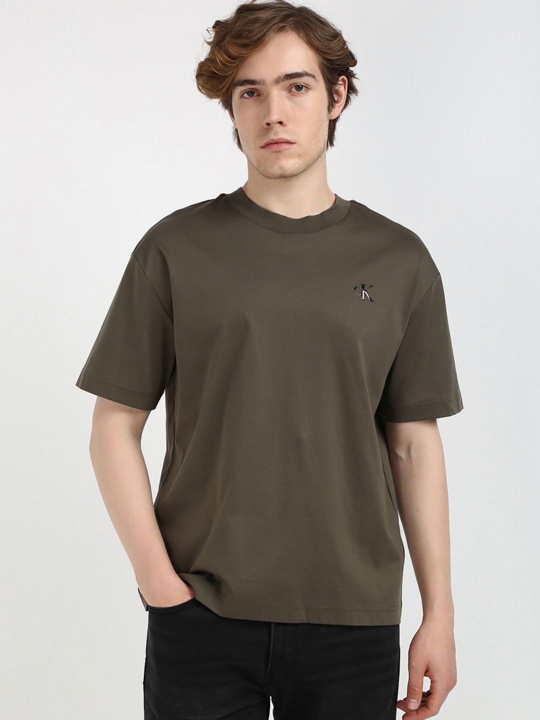 

Calvin Klein Jeans Men Solid Round Neck Cotton Relaxed Fit T-shirt, Brown