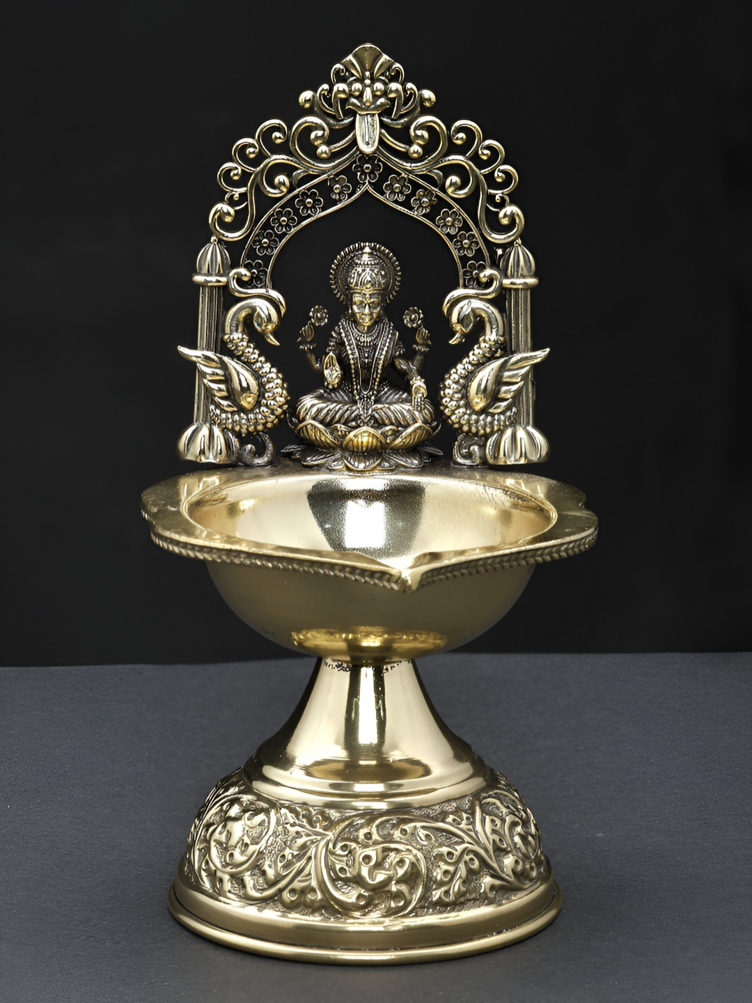 

Exotic India Brass Goddess Lakshmi Oil Lamp with Kirtimukha Arch, Gold