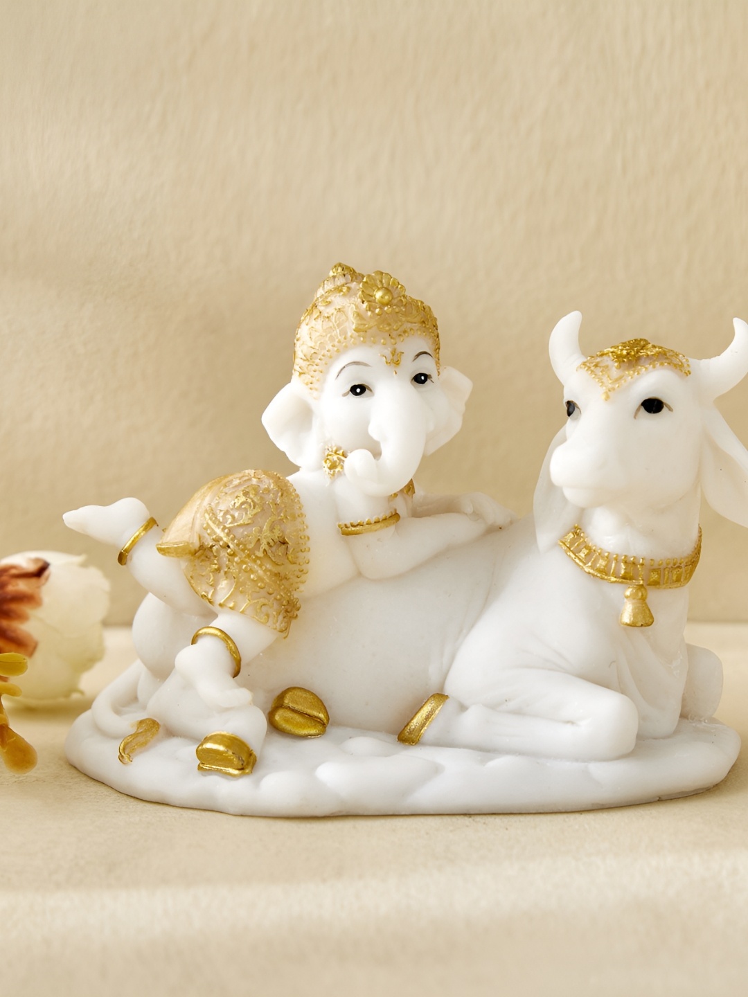 

Home Centre Dhayana Mira White & Gold-Toned Ganesha on Cow Showpiece