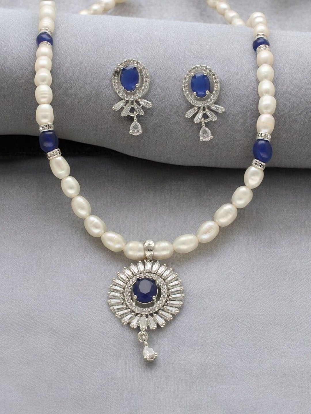 

Sri Jagdamba Pearls Dealer Silver- Plated Stone Studded & Beaded Jewellery Set