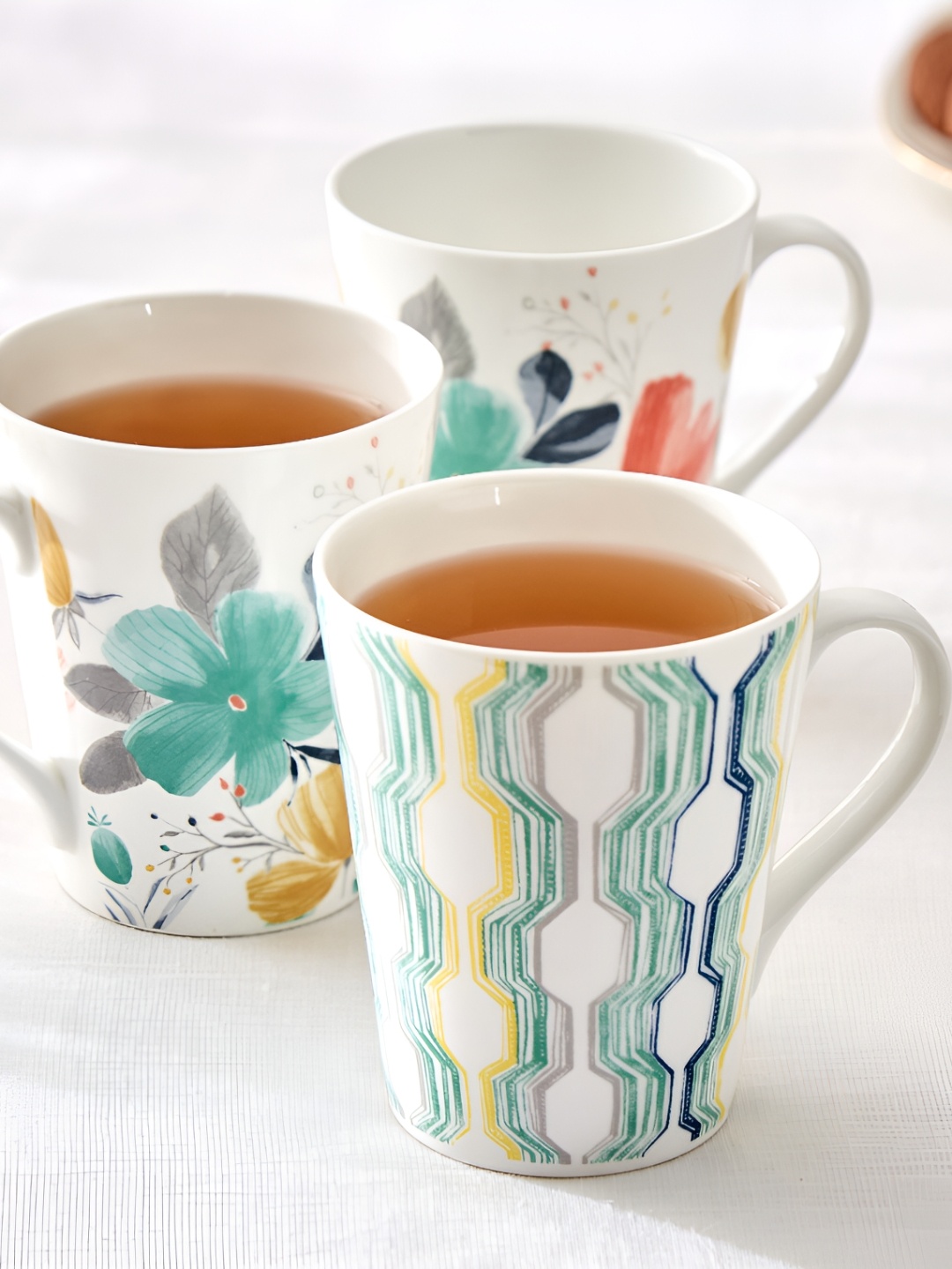 

Home Centre White & Green Printed Bone China Glossy Mugs Set of Cups and Mugs