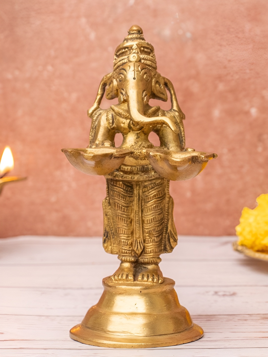 

The Advitya Gold Toned Lord Ganesha Brass Idol Aarti Diya