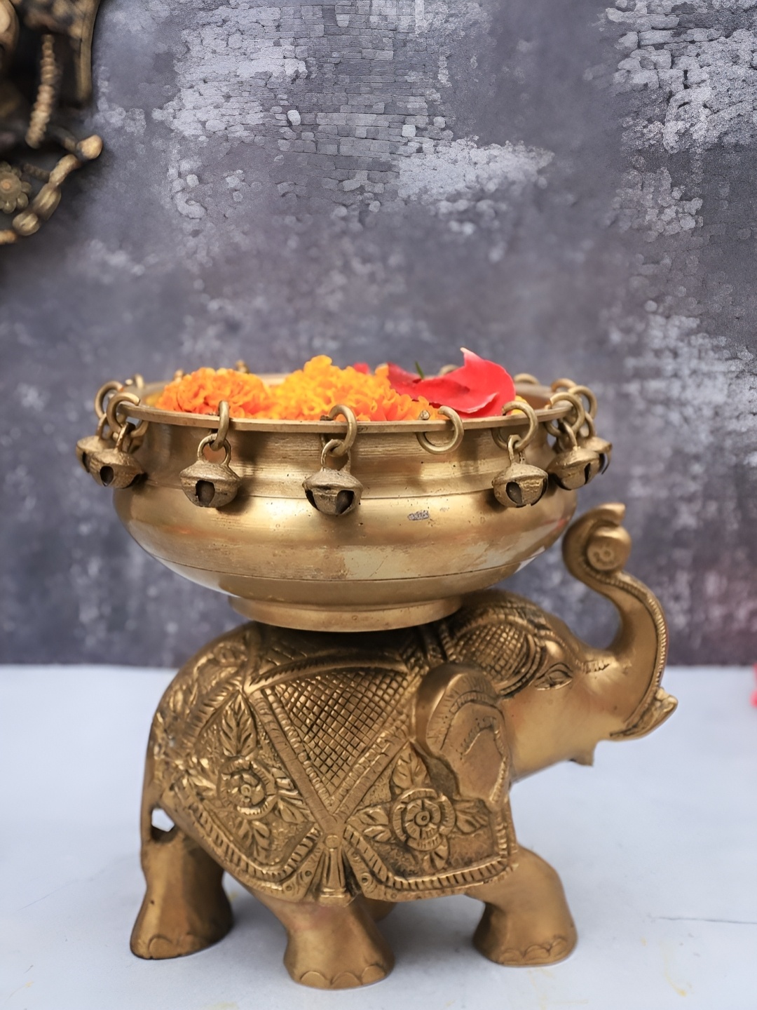 

The Advitya Gold-toned Brass Urli Bowl With Bells on Elephant