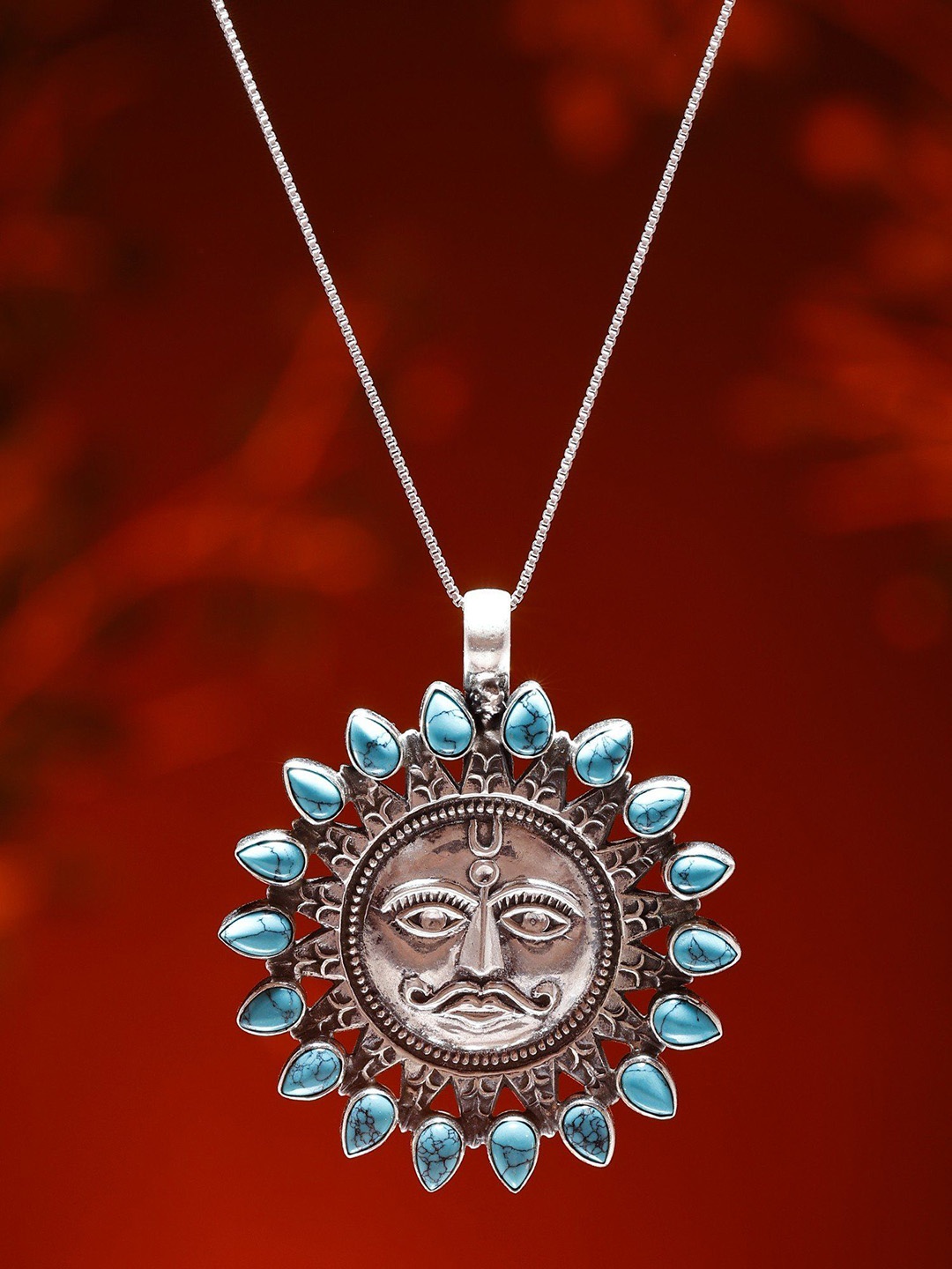 

Exotic India Sterling Silver Lord Surya Pendant with Tibetan Turquoise Gemstone