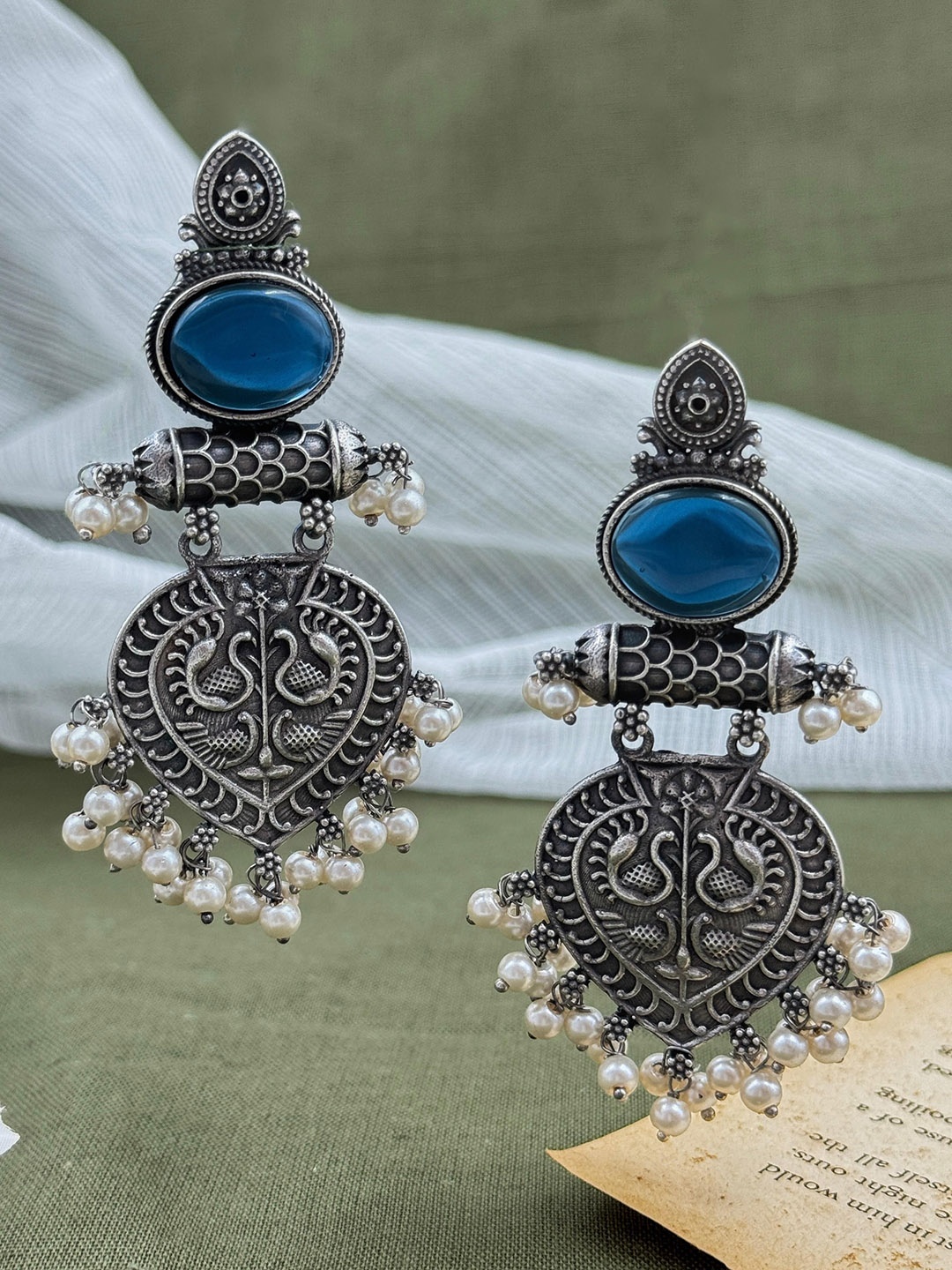 

NAMAN ARTS Silver-Plated Kundan Studded Contemporary Oxidised Drop Earrings