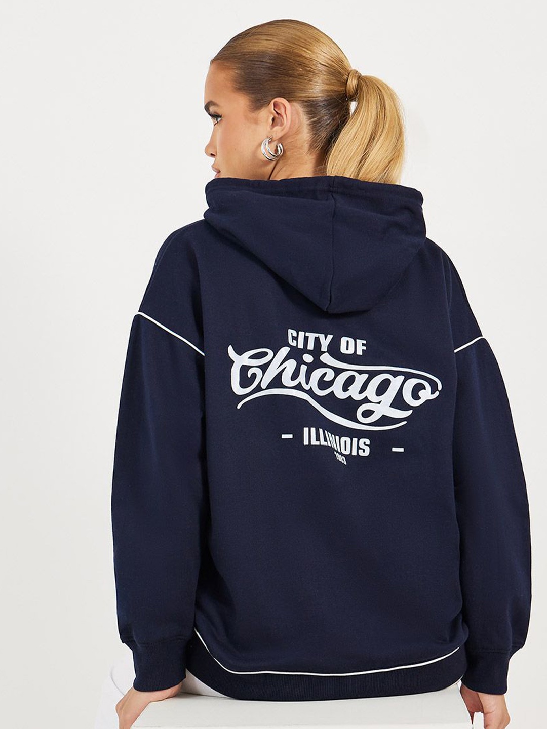

Styli Women Oversized Fit Longline Slogan Hoodie with Contrast Stitch, Navy blue