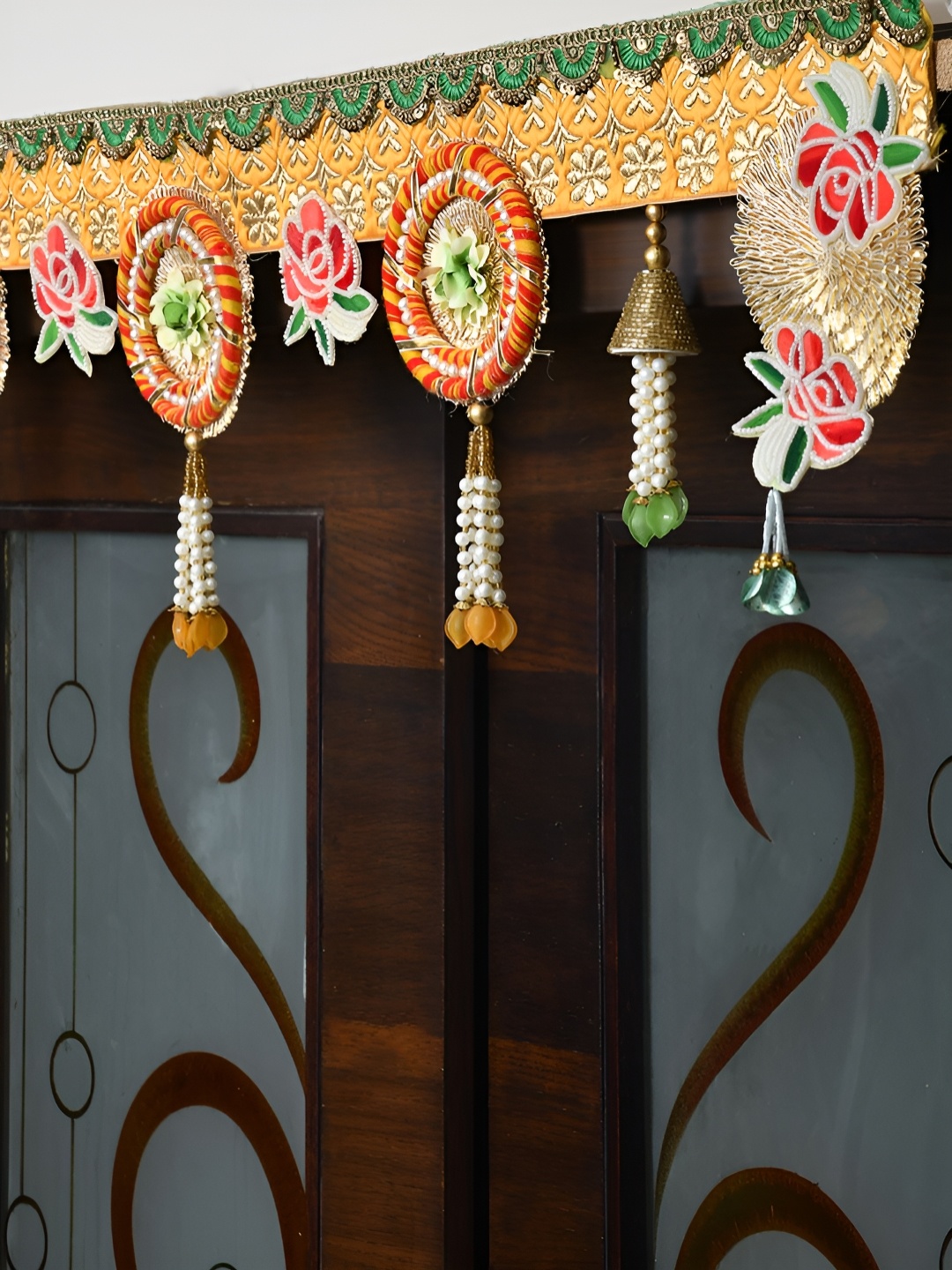 

Aapno Rajasthan Gold-Toned & Yellow Floral Embellished Wall Door Hanging Toran