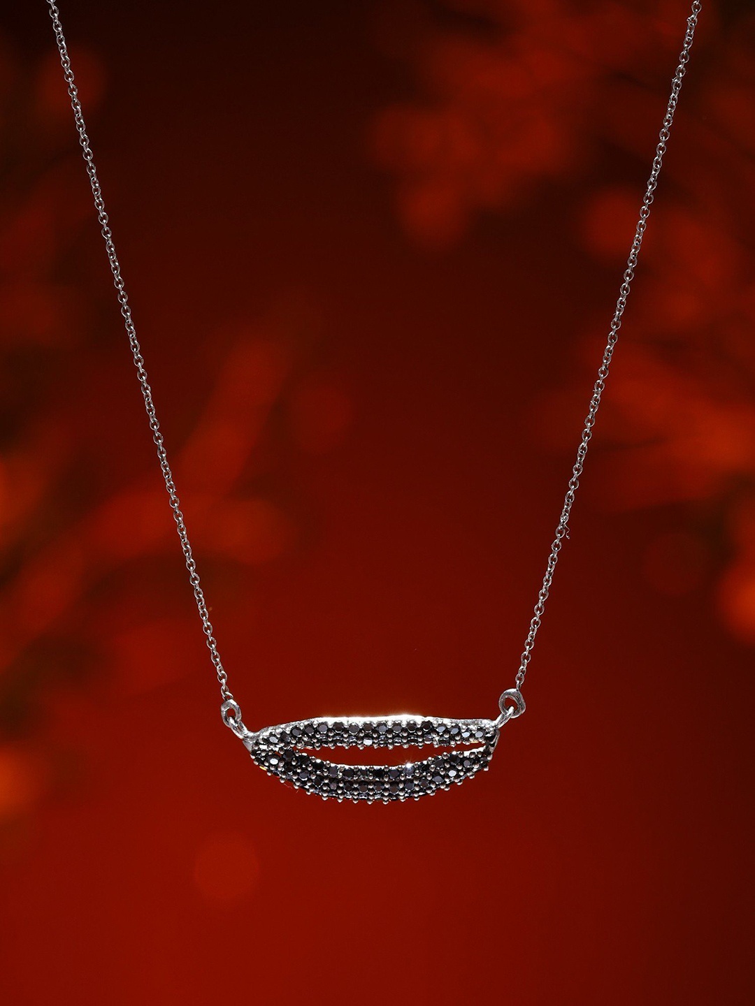 

Exotic India Sterling Silver Black Onyx Lip Shape Pendant