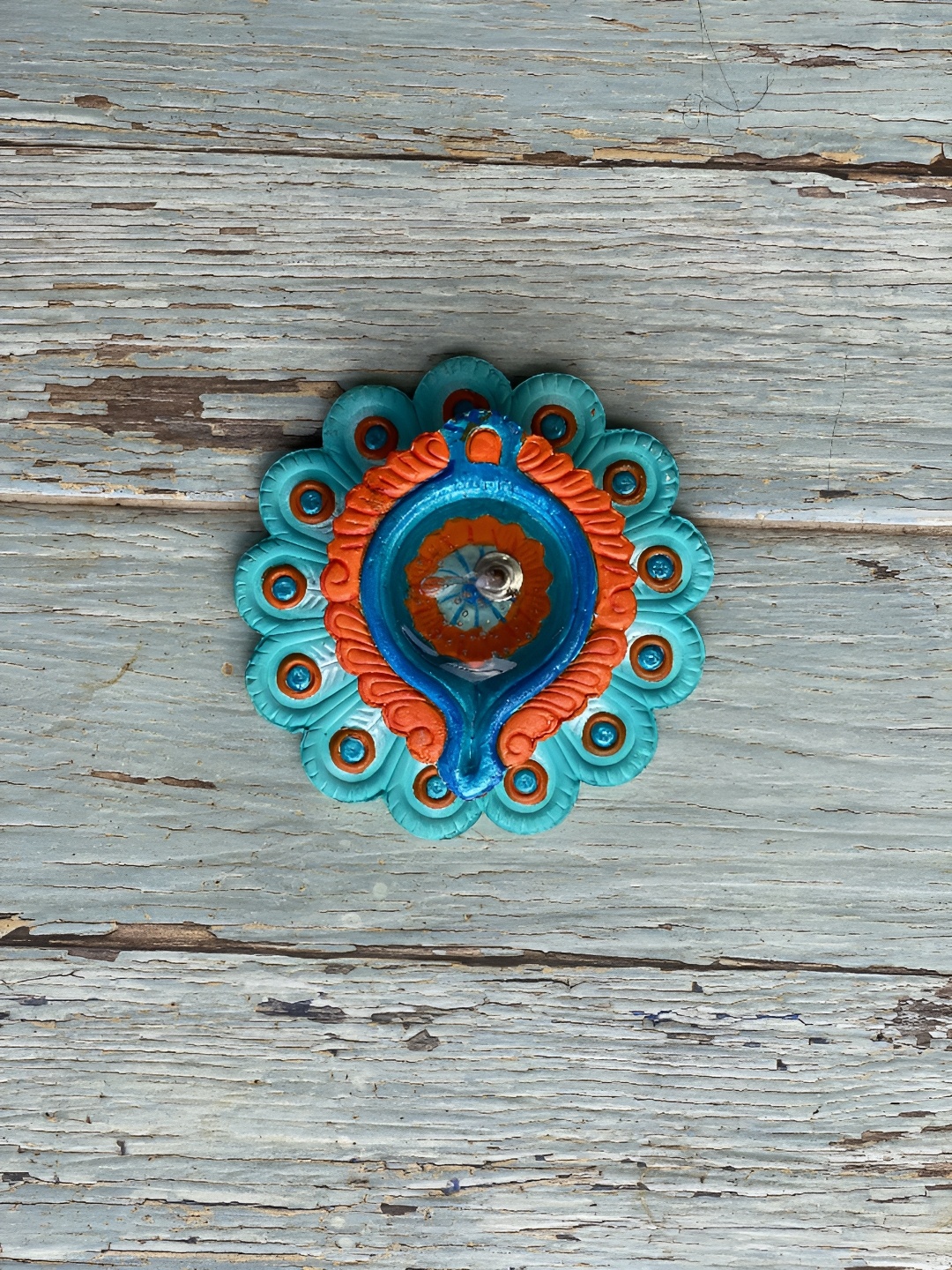 

Ariana Turquoise Blue & Orange Peacock Terracota Gel Scented Diya