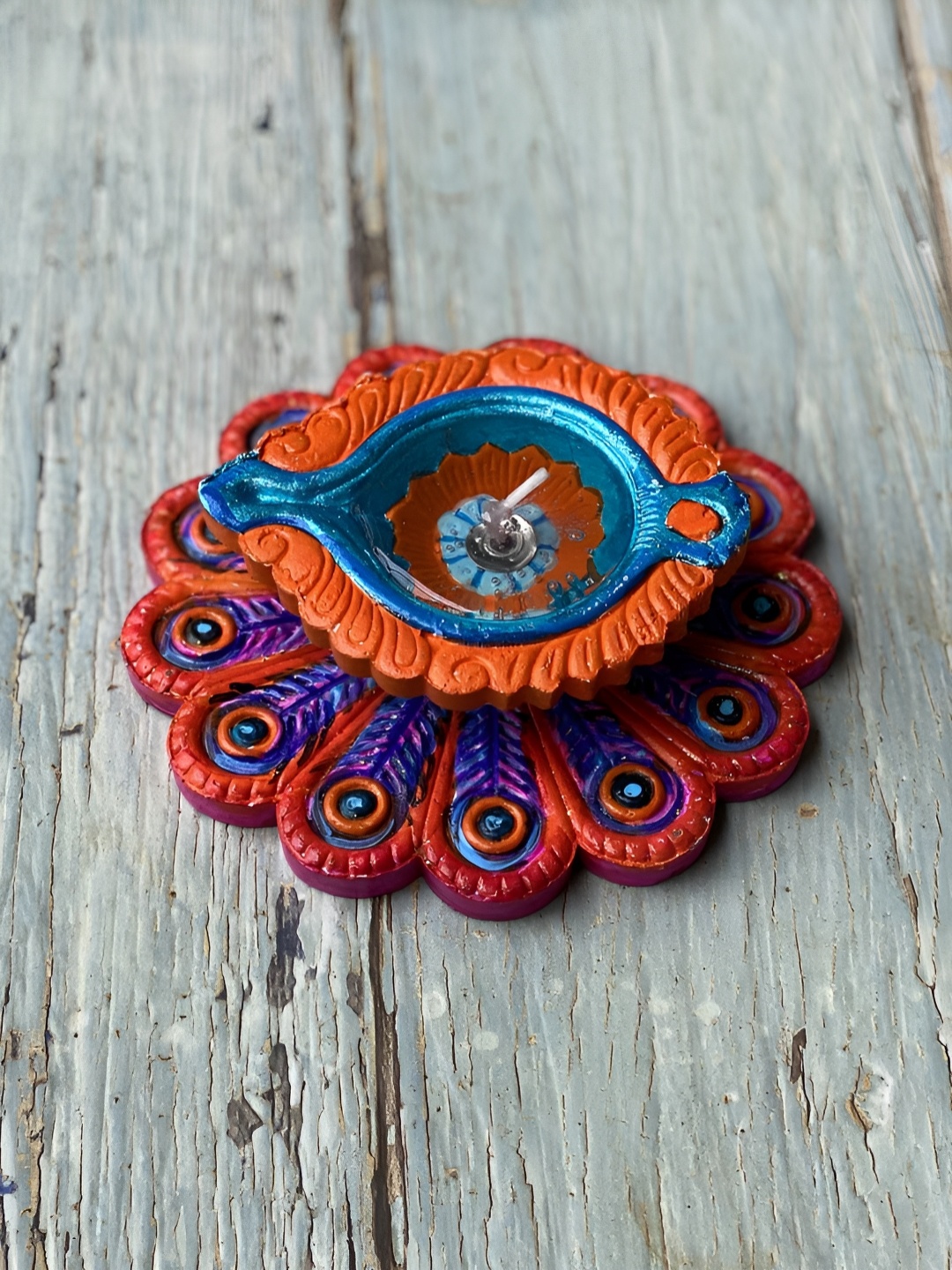 

Ariana Red & Blue Peacock Terracota Gel Scented Diya