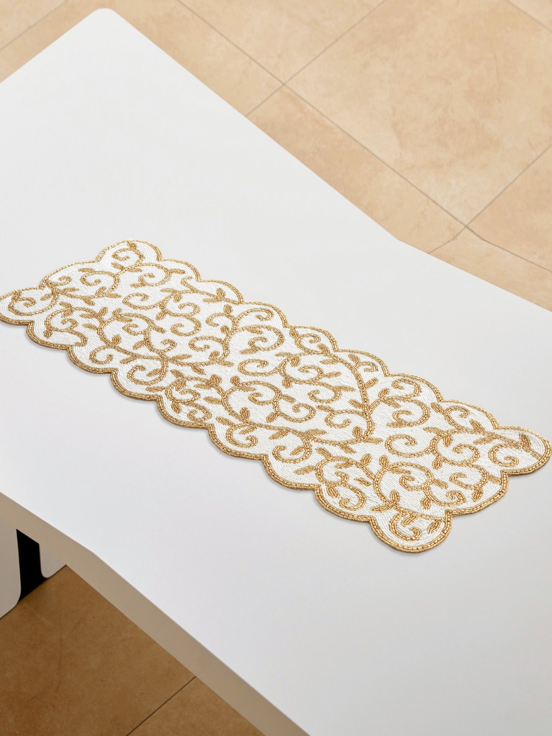 

Home Centre Halcyon Swirl Goldtoned and white Beaded Table Runner, Gold