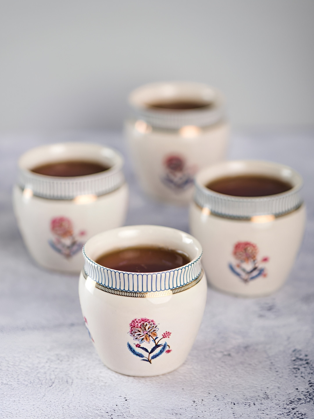 

Fabindia Off White & Red 4 Pieces Floral Ceramic Glossy Kulladhs Set of Cups and Mugs