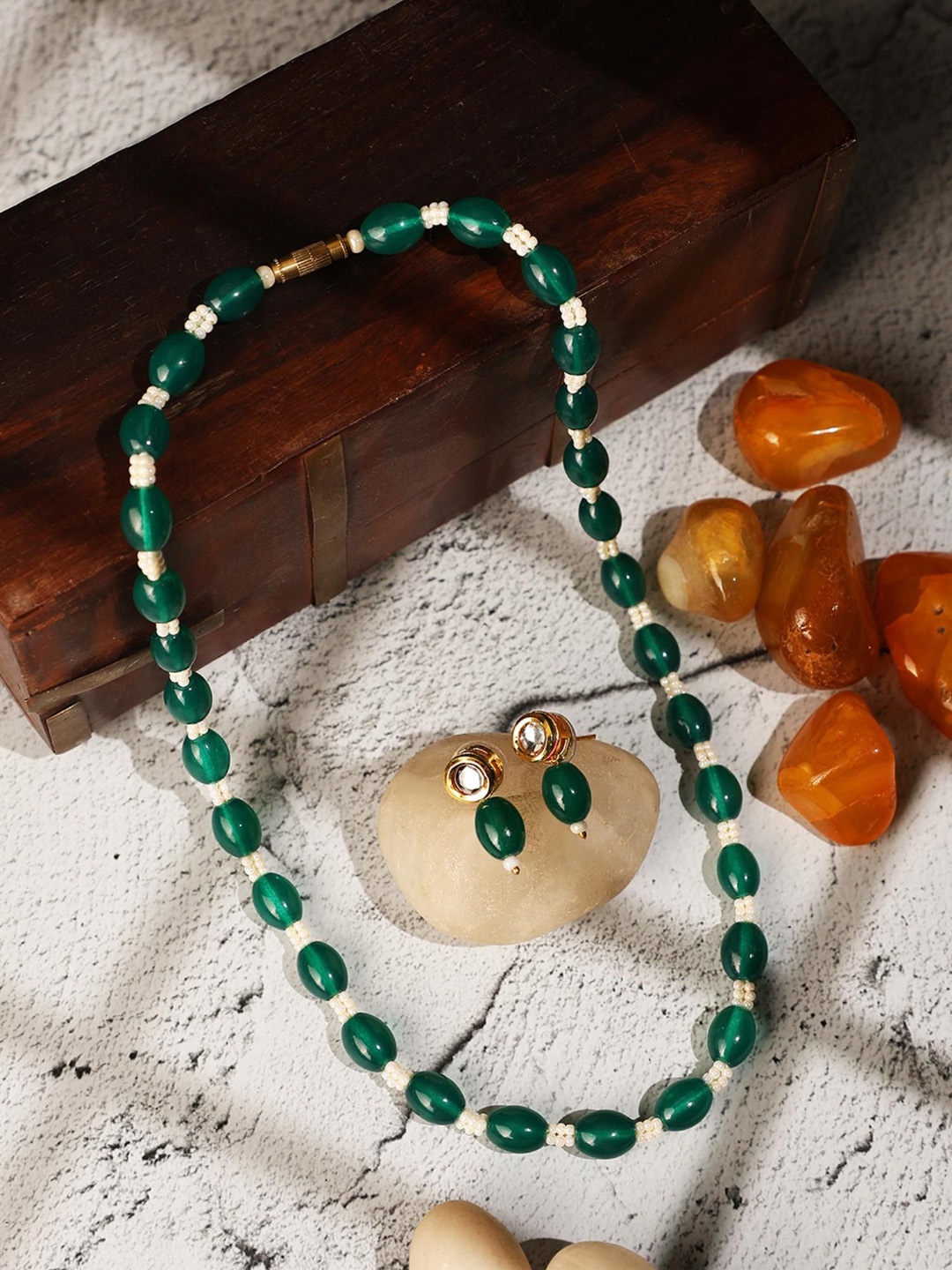

ANIKAS CREATION Gold Plated Pearl Bedded Jewellery Set