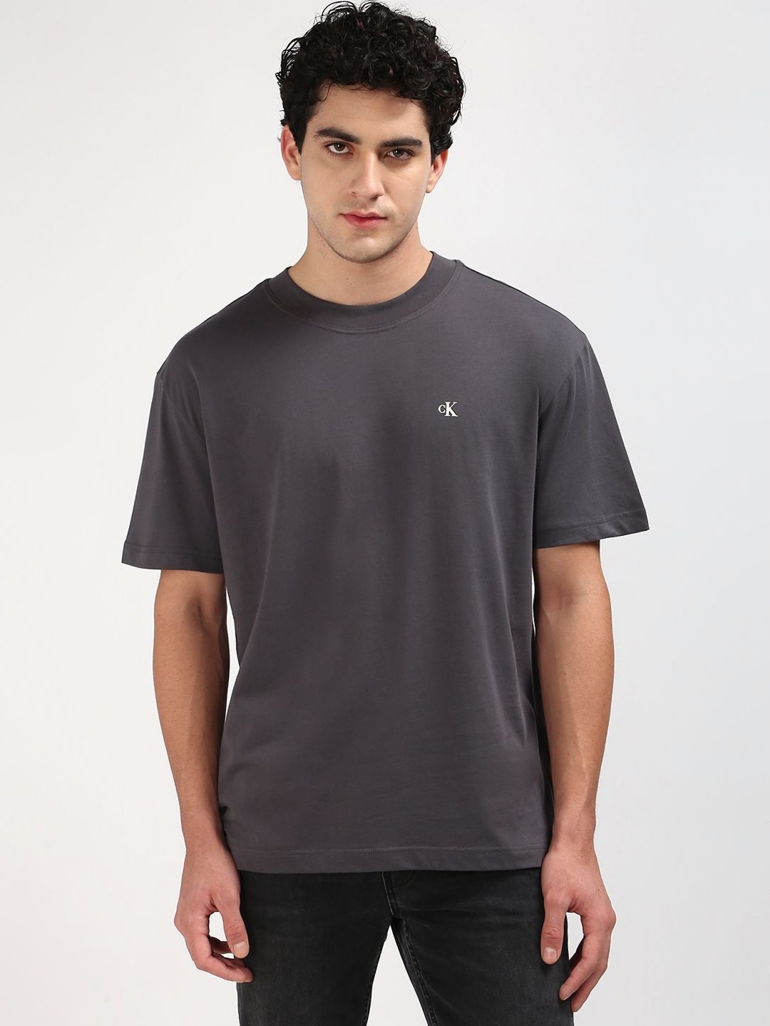 

Calvin Klein Jeans Men Solid Round Neck Cotton T-shirt, Black