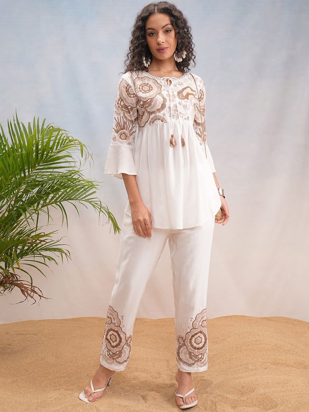 

Vishudh Off White Floral Embroidered Bell Sleeves Tie-up Neck Tunic With Trousers