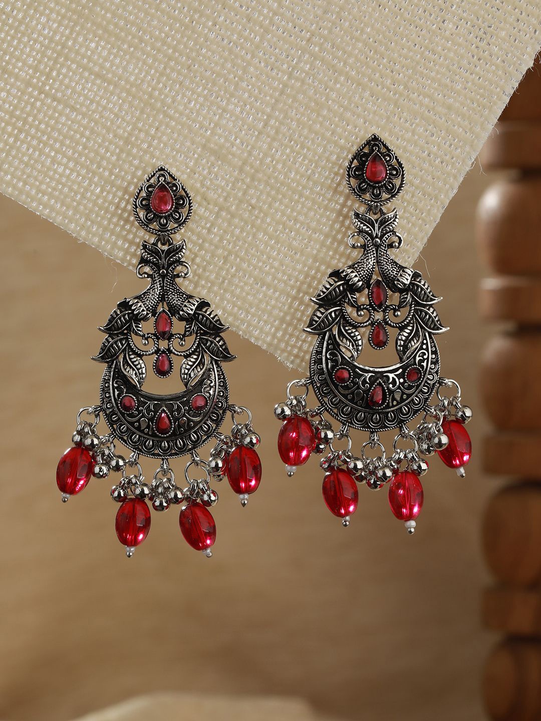 

Jazz and Sizzle Silver-Plated Peacock Shaped Chandbalis Earrings, Red