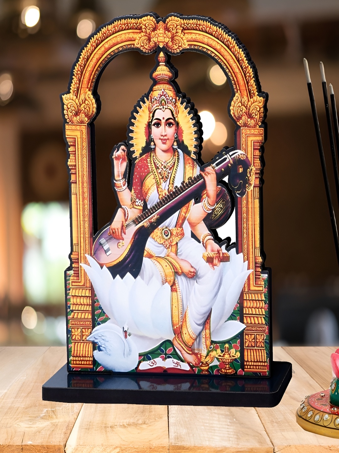 

Home Delight Gold Toned & White Lord Saraswati Wooden Idol Showpiece