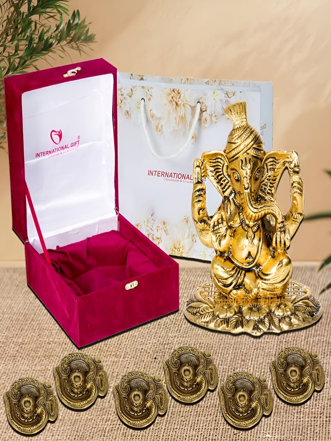 

INTERNATIONAL GIFT Gold-Toned Religious Figurine Showpiece With Diyas & Velvet Box