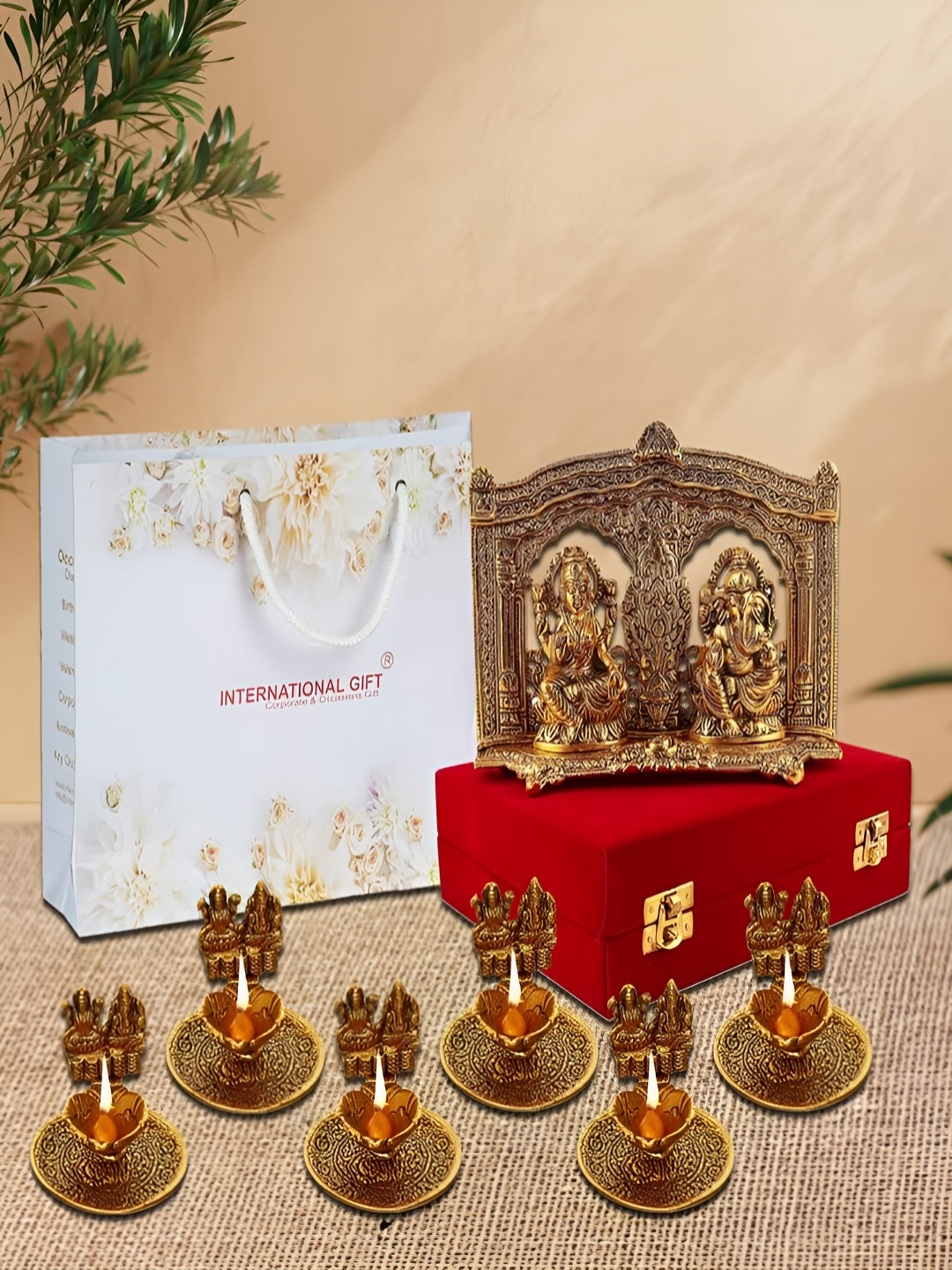 

INTERNATIONAL GIFT Gold-Toned Religious Figurine Showpiece With Diyas & Velvet Box